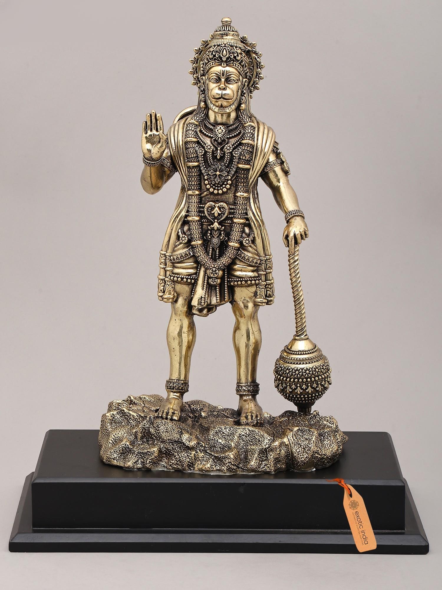 14" Superfine Idol of Lord Hanuman in Blessing Gesture with Mace and Wood Base | Brass Sculpture: Embodiment of Strength and Devotion: Lord Hanuman Brass Idol This magnificent brass idol captures the divine essence of Lord Hanuman, the devoted son of Vayu and the ardent follower of Lord Rama.