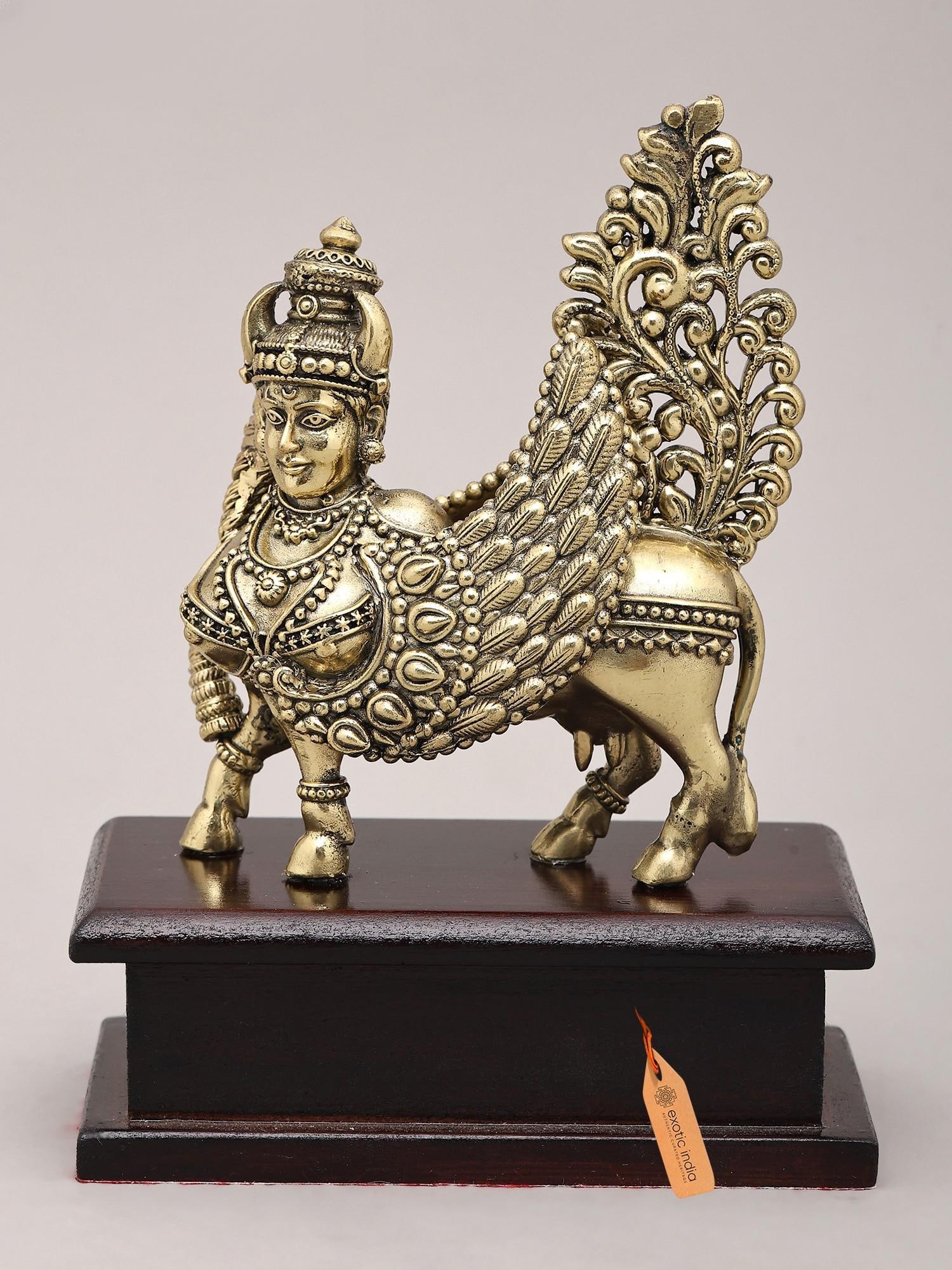 5" Small Superfine Goddess Kamdhenu on Wood Base | Brass Sculpture: The Divine Cow of Plenty: A Symbol of Auspiciousness This exquisite brass sculpture captures the divine Kamdhenu, the celestial cow, a being of immense significance in Hindu mythology. Kamdhenu is not