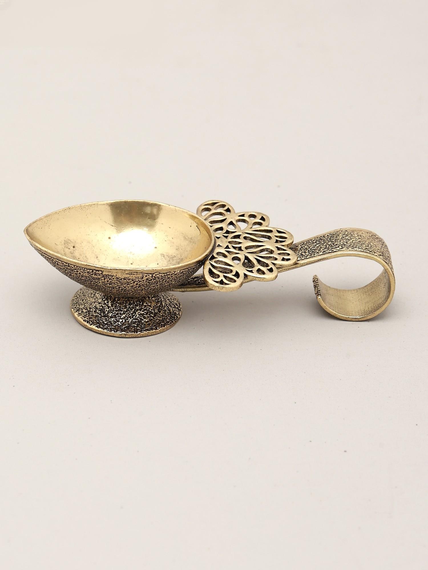 4" Small Superfine Handheld Brass Diya | Puja Item: An Emblem of Divine Light and Tradition This exquisitely crafted brass diya is more than just a lamp; it is a tangible connection to the rich tapestry of Indian spiritual practices and cultural herita