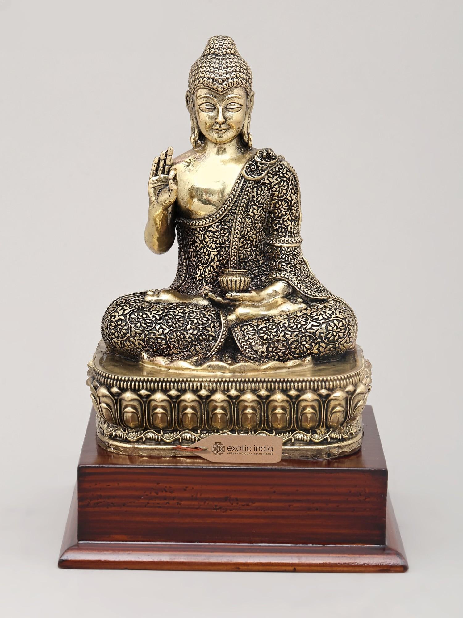 7" Superfine Vitark Posture Idol of Lord Buddha with Wood Base | Brass Statue: The Gesture of Instruction and Wisdom This exquisite brass idol depicts Lord Buddha in the Vitark Mudra, a gesture of teaching, discussion, and the transmission of knowledge. With his right hand