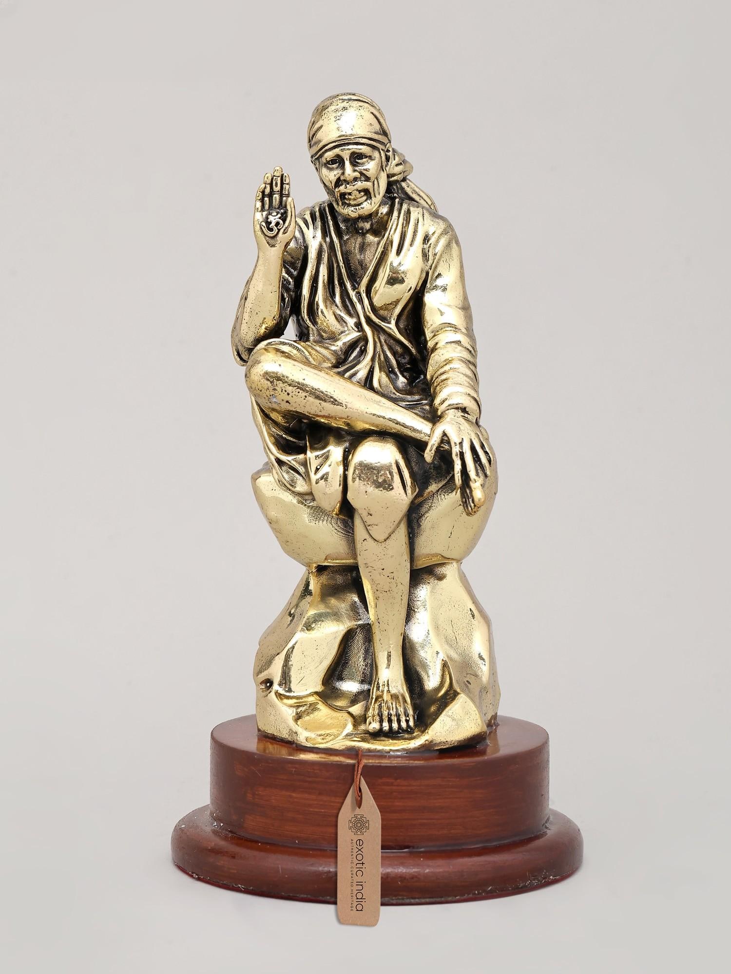 6" Superfine Idol of Saint Sai Seated on Asana with Wood Base | Brass Sculpture: 6" Superfine Idol of Saint Sai Seated on Asana with Wood Base | Brass Sculpture Reserve: $94.00 Shipping: Domestic: Shipping rates are determined by destination International: Foreign shipping rates