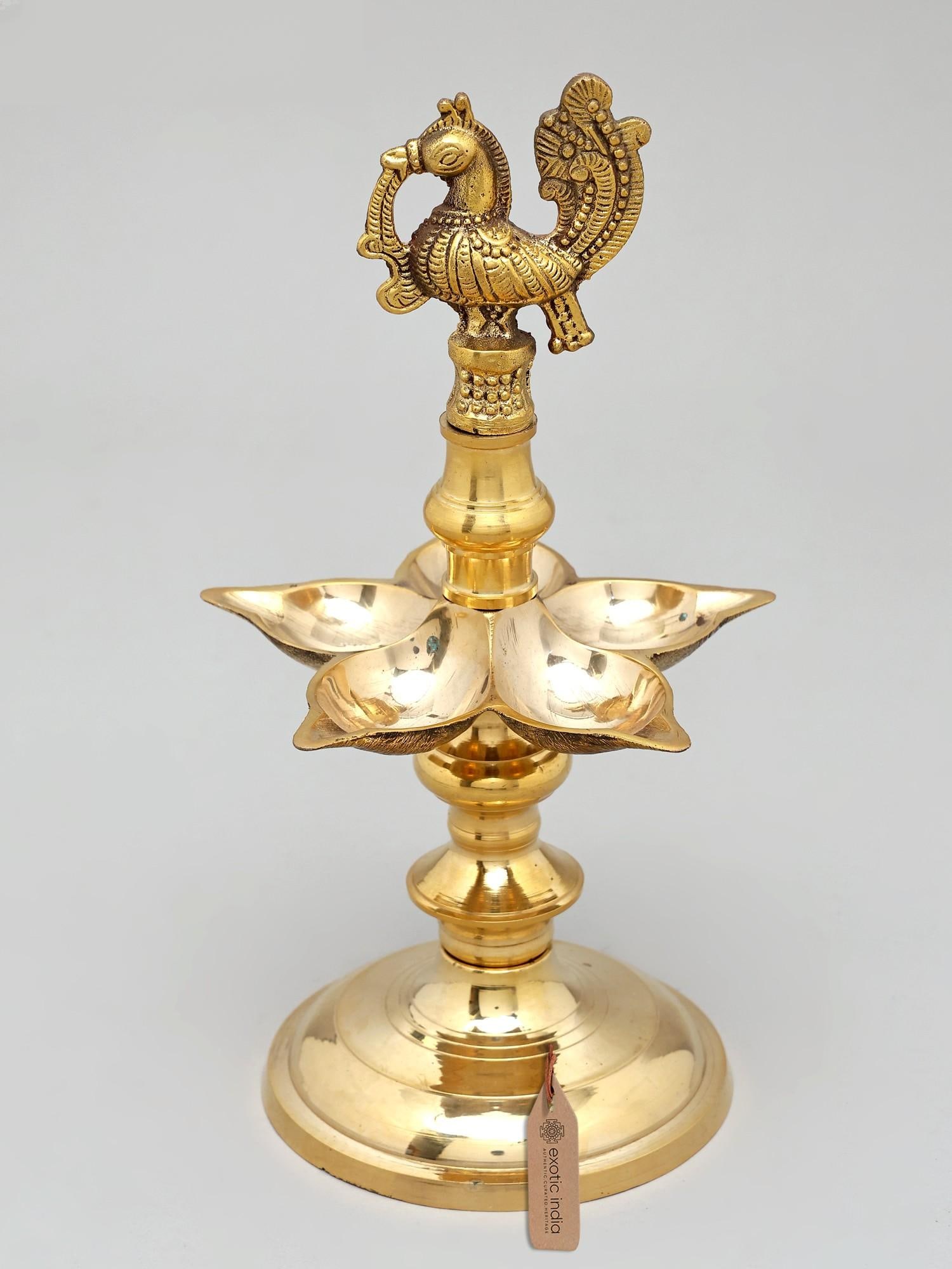 11" Five Wicks Peacock Lamp in Brass | Handmade | Made In India: A Radiant Symbol of Auspiciousness and Divine Presence This exquisite brass lamp, meticulously handcrafted in India, is more than just a source of light; it is a potent symbol of prosperity,