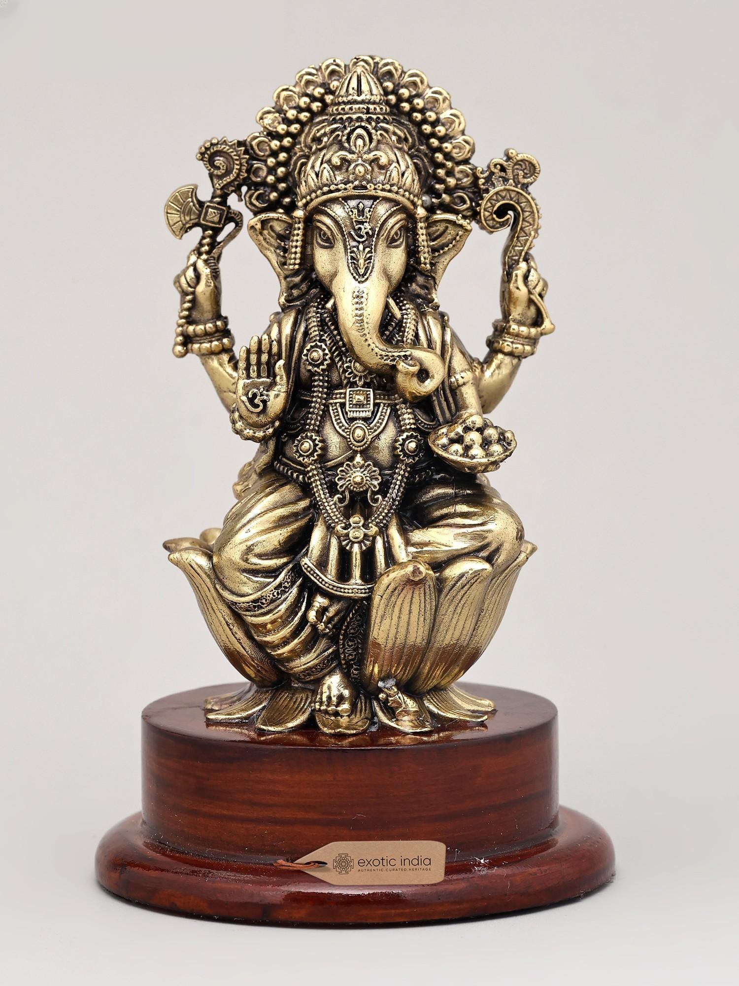 5" Small Superfine Lord Ganesha in Blessing Gesture with Wood Base | Brass Sculpture: The Auspicious Presence of Vighnaharta Welcome the divine presence of Lord Ganesha, the remover of obstacles and the god of beginnings, into your sacred space with this exquisite superfine brass