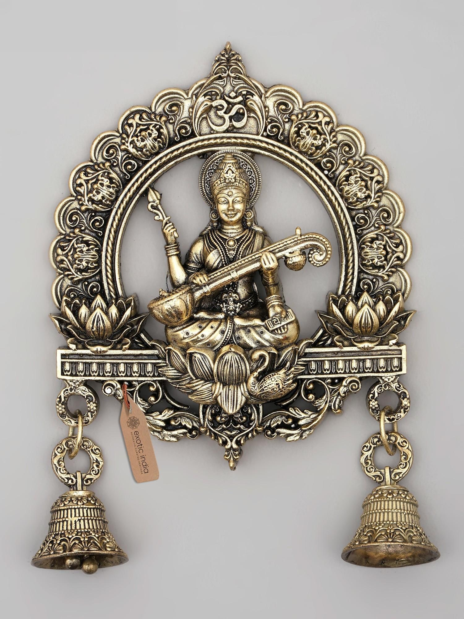 6" Small Superfine Goddess Saraswati Wall Hanging Statue with Bells: The Embodiment of Knowledge and Art This exquisite brass wall hanging captures the serene presence of Goddess Saraswati, the Hindu deity of knowledge, music, art, wisdom, and learning. Crafted with ex