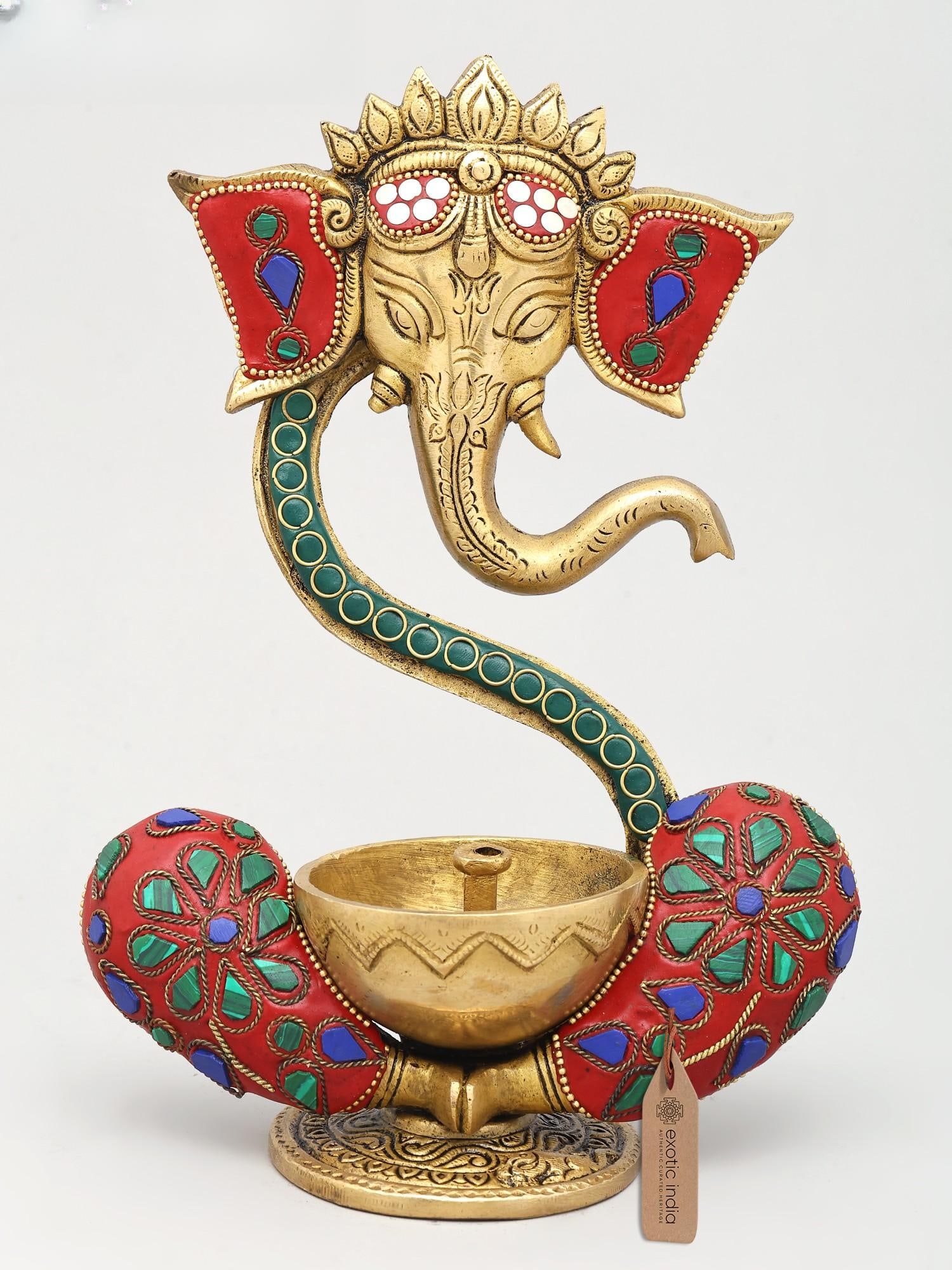 9" Ganesha Wick Lamp in Brass with Inlay Work | Handmade | Made in India: A Beacon of Divine Grace This exquisite brass wick lamp embodies the auspicious presence of Lord Ganesha, the revered remover of obstacles and patron of new beginnings. Crafted with meticulous care