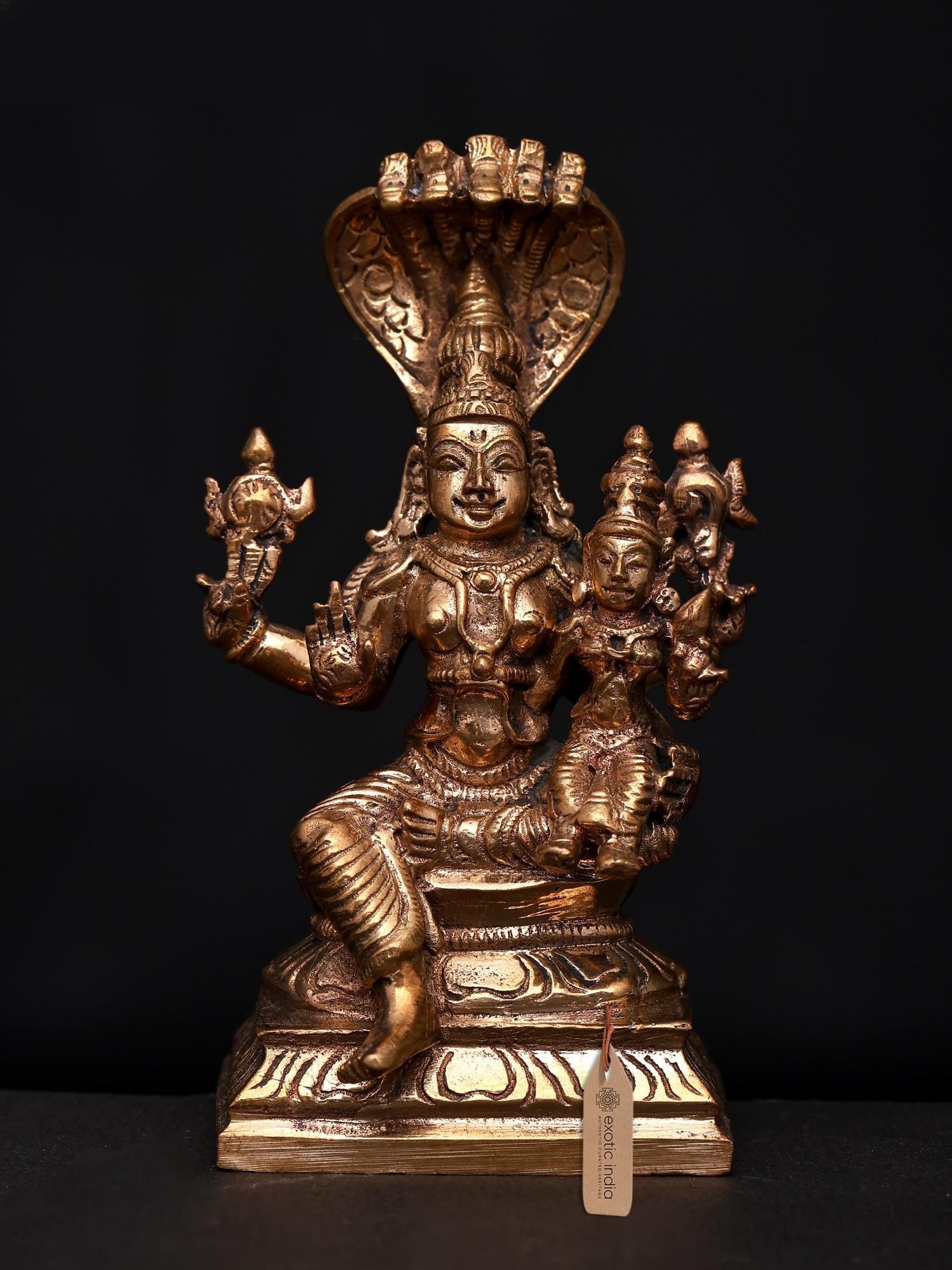 4" Small Lord Vishnu and Goddess Lakshmi Seated on Lotus | Bronze Statue | Made in India: Divine Embrace: The Auspicious Union of Vishnu and Lakshmi This exquisite bronze statue captures the serene and powerful presence of Lord Vishnu, the preserver of the universe, seated in divine