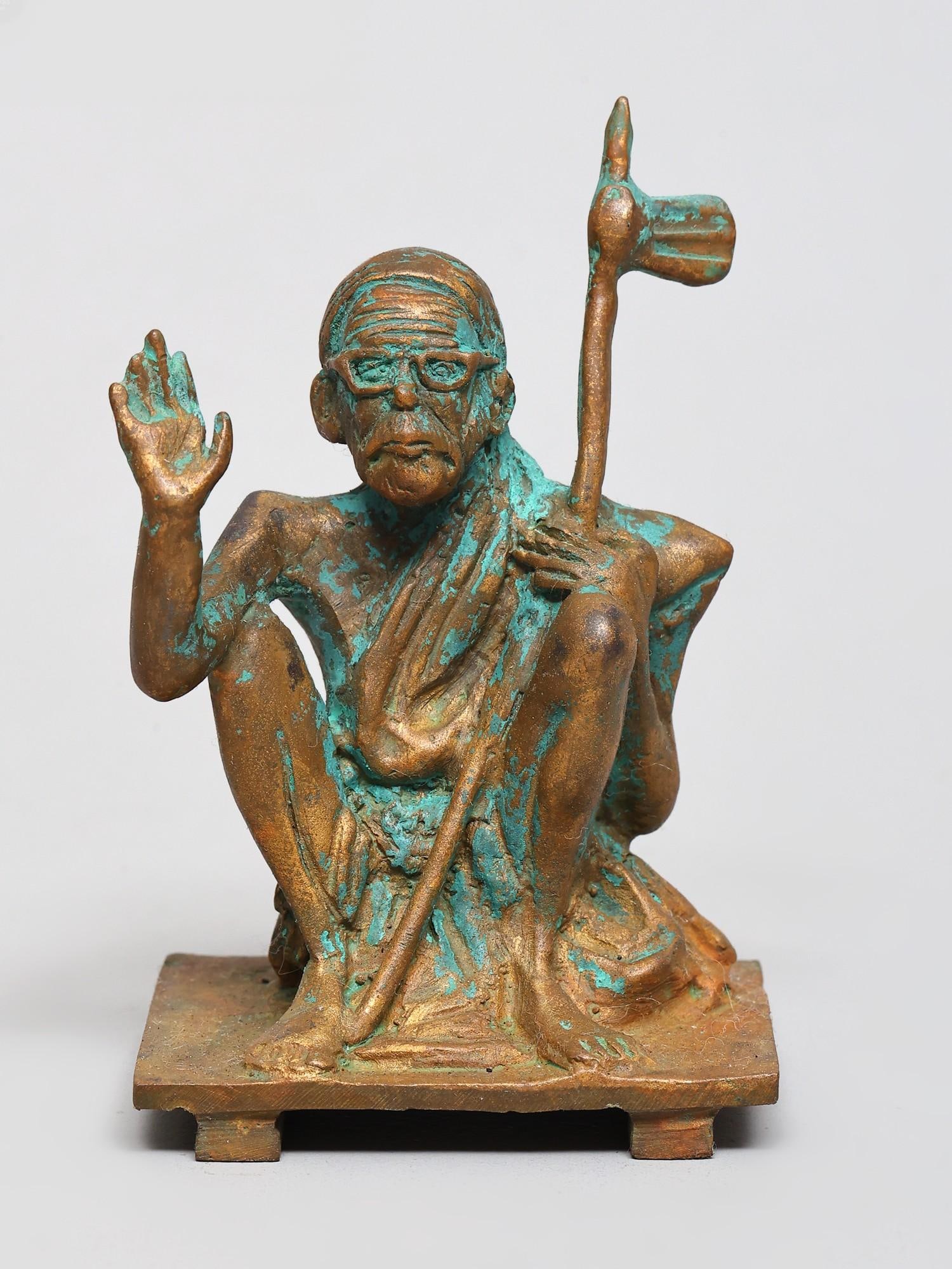3" Small Kanchi Maha Periyava Saint Seated on Pedestal | Bronze Statue | Made in India: A Serene Embodiment of Wisdom This exquisite bronze sculpture captures the serene countenance and profound presence of a revered saint, seated in a posture of deep meditation and spiritual authority.