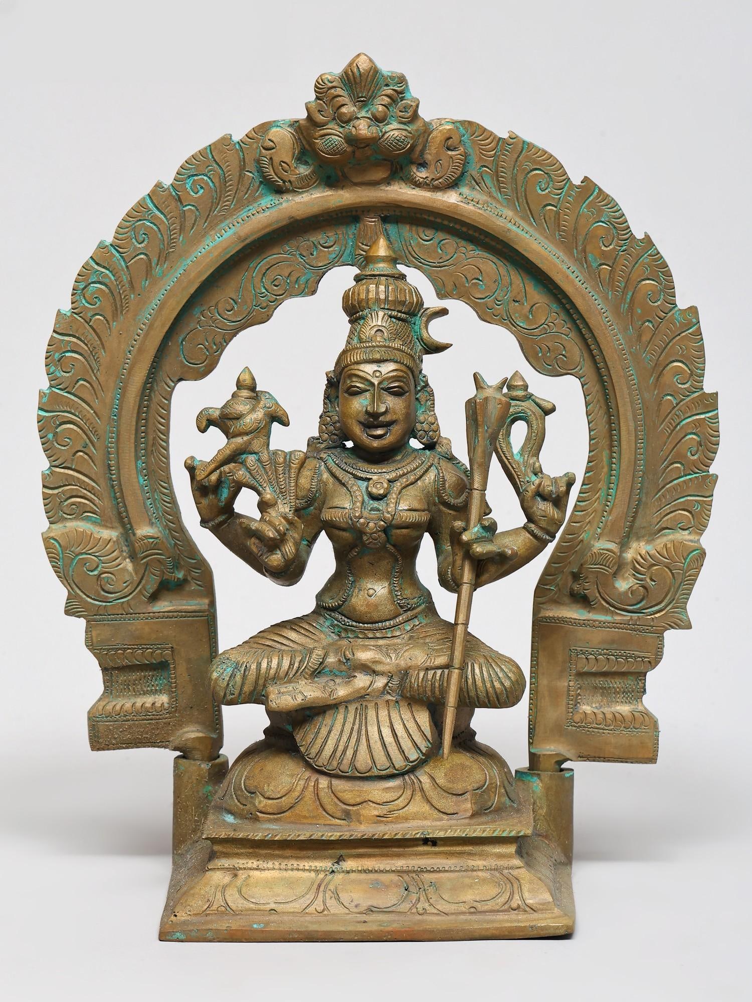 10" Four Armed Goddess Rajarajeshwari Seated on Kirtimukha Throne | Bronze Sculpture | Made in India: The Radiant Queen of Queens This exquisite bronze sculpture depicts the divine form of Goddess Rajarajeshwari, a powerful and benevolent deity revered as the "Queen of Queens." Her presence emanates a