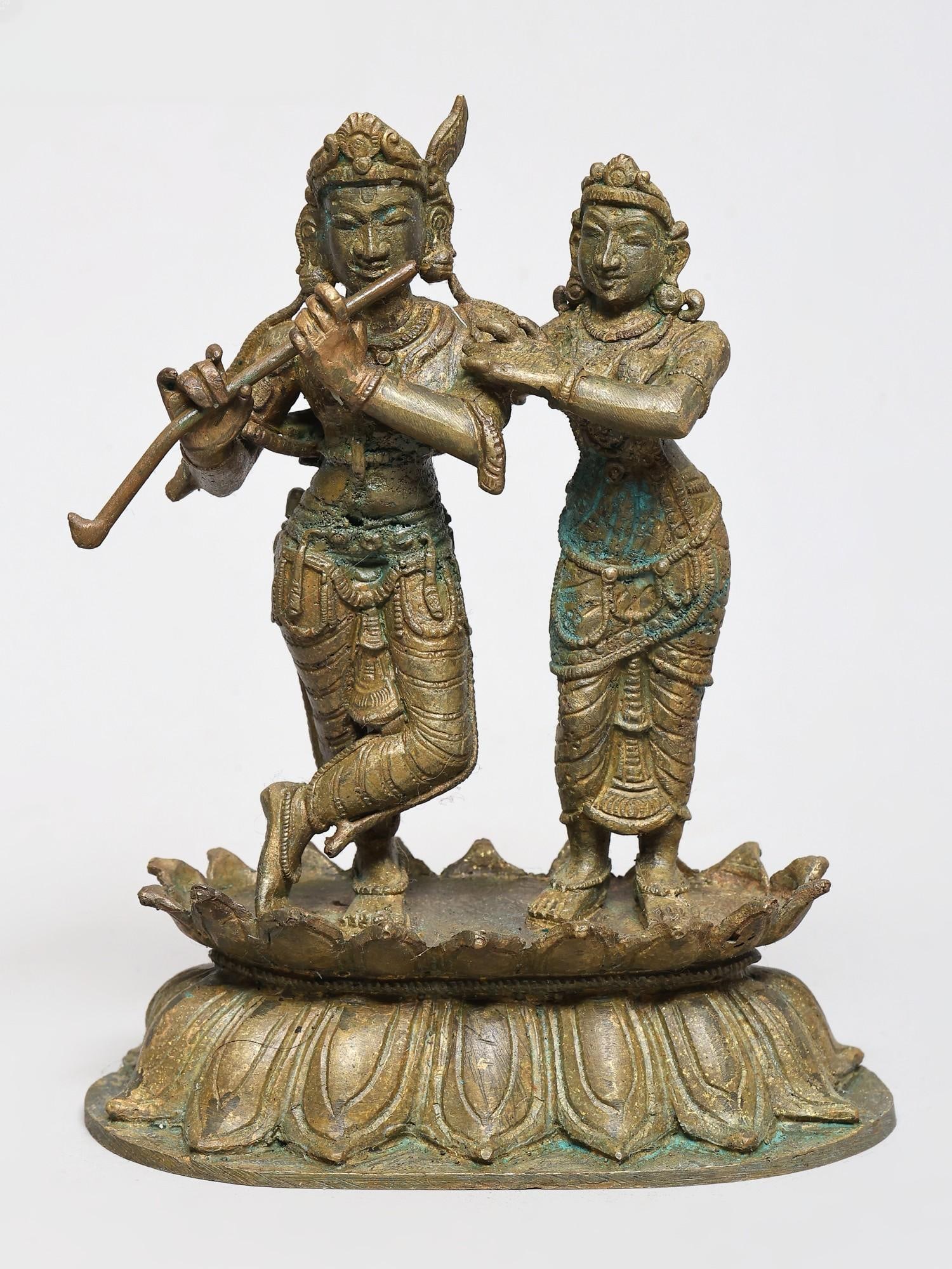 5" Small Radha and Krishna Standing on Lotus - The Divine Pair | Bronze Idol | Made in India: The Divine Embrace: Radha and Krishna in Bronze This exquisite bronze sculpture captures the eternal love and divine play between Lord Krishna and his beloved Radha. Crafted with meticulous artistry i
