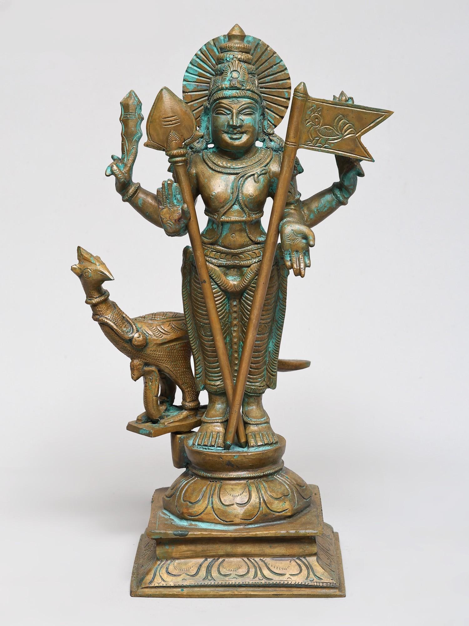 12" Four Armed Lord Murugan Swami (Kartikeya) with Vel and Peacock | Bronze Statue | Made in India: The Victorious Skanda: A Majestic Bronze Depiction This exquisite bronze statue captures the divine presence of Lord Murugan, also known as Skanda, Kartikeya, or Subramanya, the commander of the celes