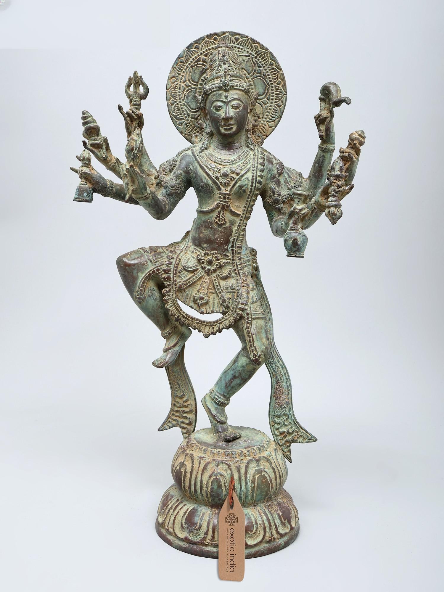 18" Eight Armed Dancing Lord Shiva (Nataraja) | Brass Statue: The Cosmic Dance of Creation and Destruction This magnificent brass statue captures the divine essence of Lord Shiva as Nataraja, the Lord of Dance. Depicted in his iconic cosmic dance, Shiva embodies