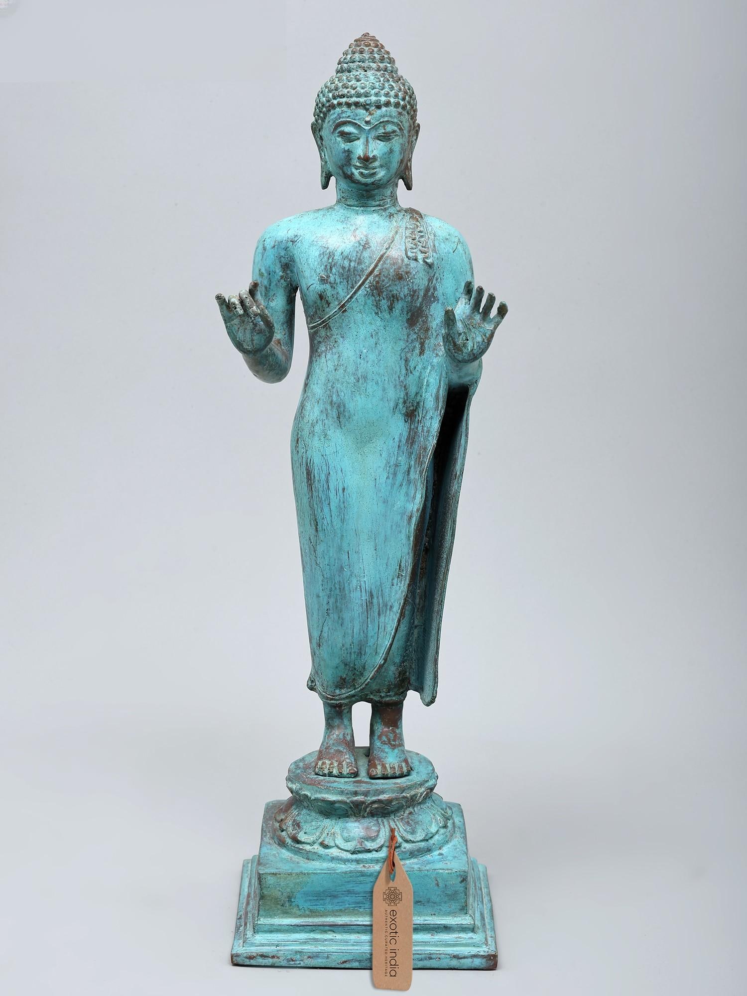 18" Turquoise Toned Standing Lord Buddha | Brass Statue: A Beacon of Serenity and Enlightenment This magnificent standing Buddha statue, cast in durable brass using the time-honored lost-wax method, embodies a profound sense of peace and spiritual