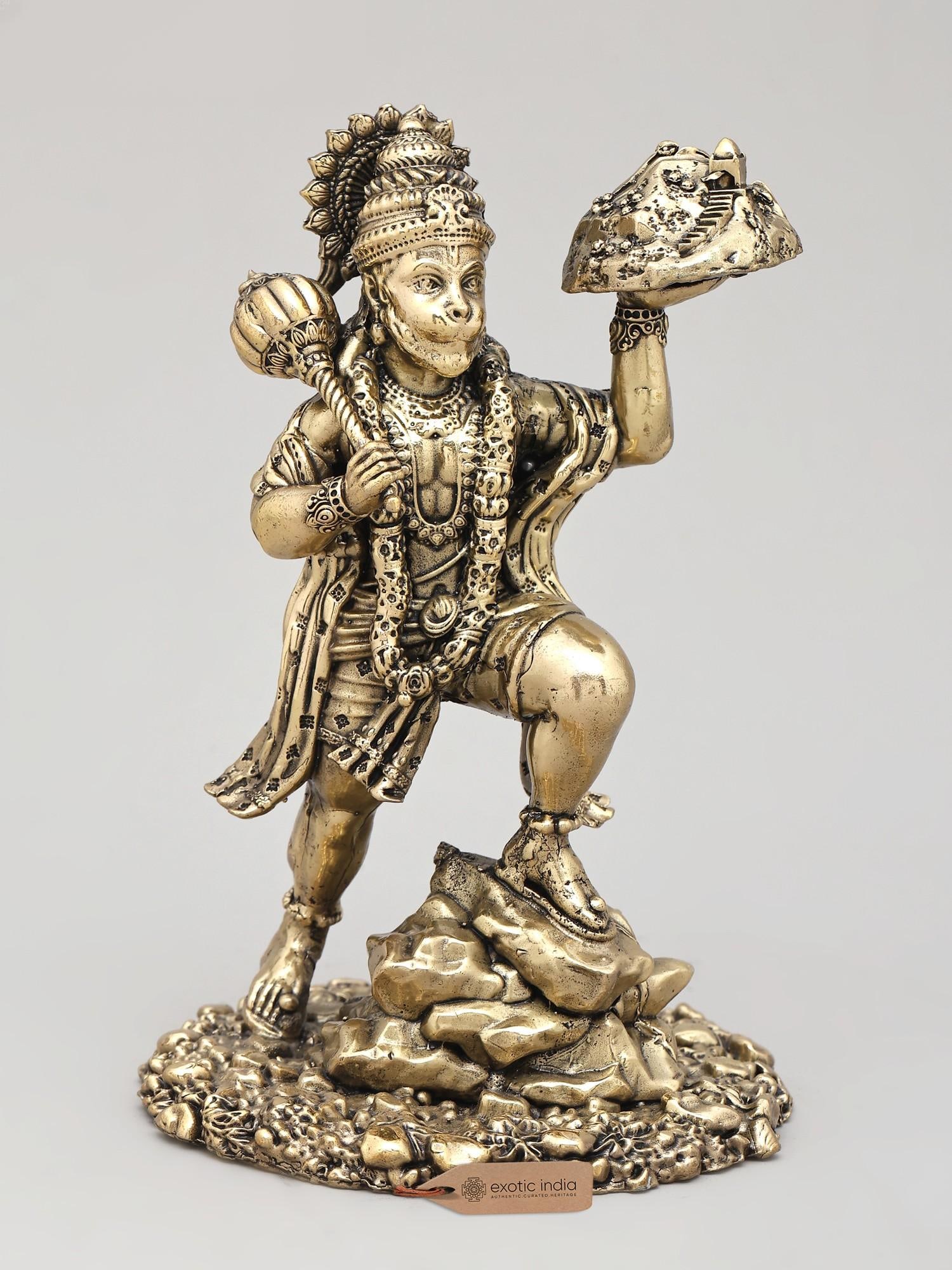 6" Small Superfine Lord Hanuman Carrying Sanjivani | Brass Statue: The Mighty Hanuman's Quest for the Sanjivani This exquisite brass statue captures a pivotal moment from the epic Ramayana, depicting Lord Hanuman in the act of carrying the Sanjivani herb. Hanuman,