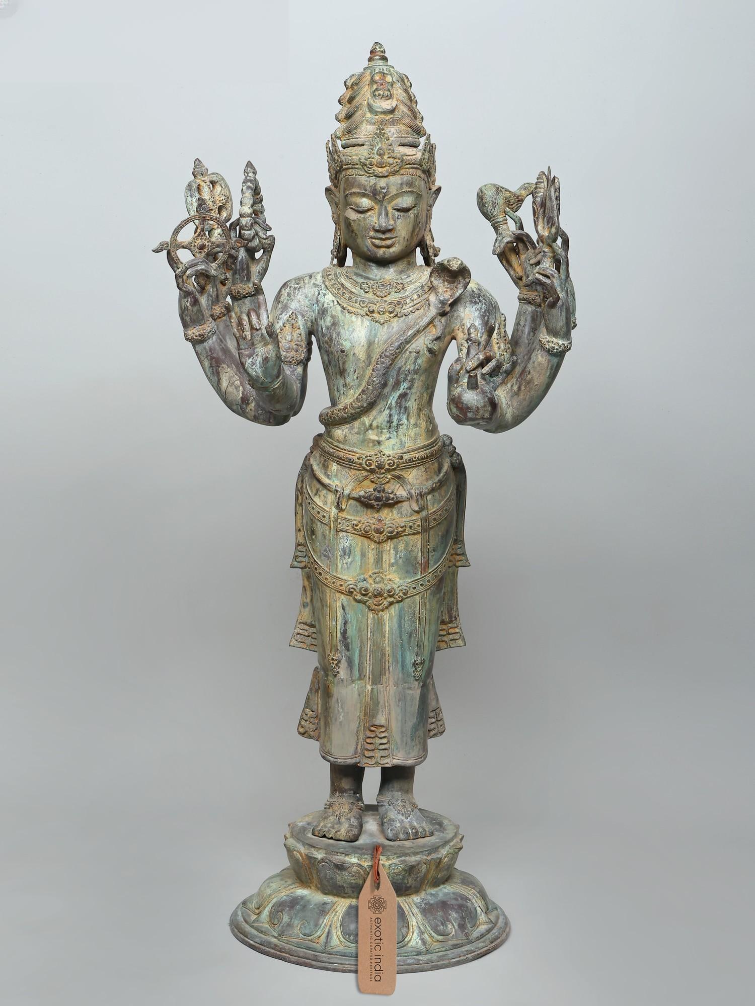 47" Large Standing Eight Armed Lord Shiva | Brass Statue: The Cosmic Dance of Lord Shiva: An Eight-Armed Brass Masterpiece This magnificent brass statue depicts Lord Shiva in his formidable and benevolent form, standing tall and commanding. With eight arms e