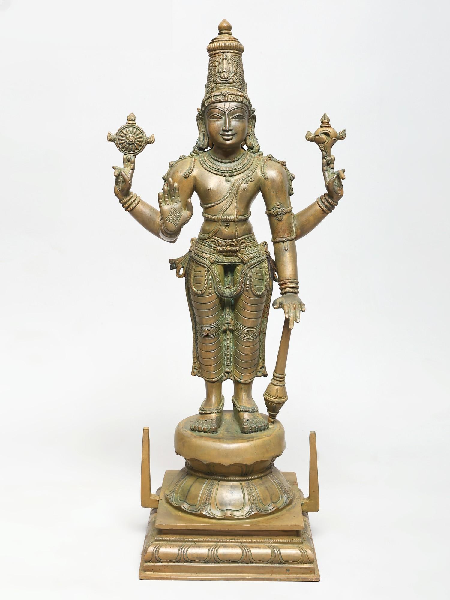 23" Four Armed Standing Lord Vishnu | Madhuchista Vidhana (Lost-Wax) | Panchaloha Bronze from: The Preserver in Panchaloha Bronze This magnificent statue depicts Lord Vishnu, the preserver and protector of the universe, in a commanding standing posture. Crafted using the ancient Madhuchista Vid