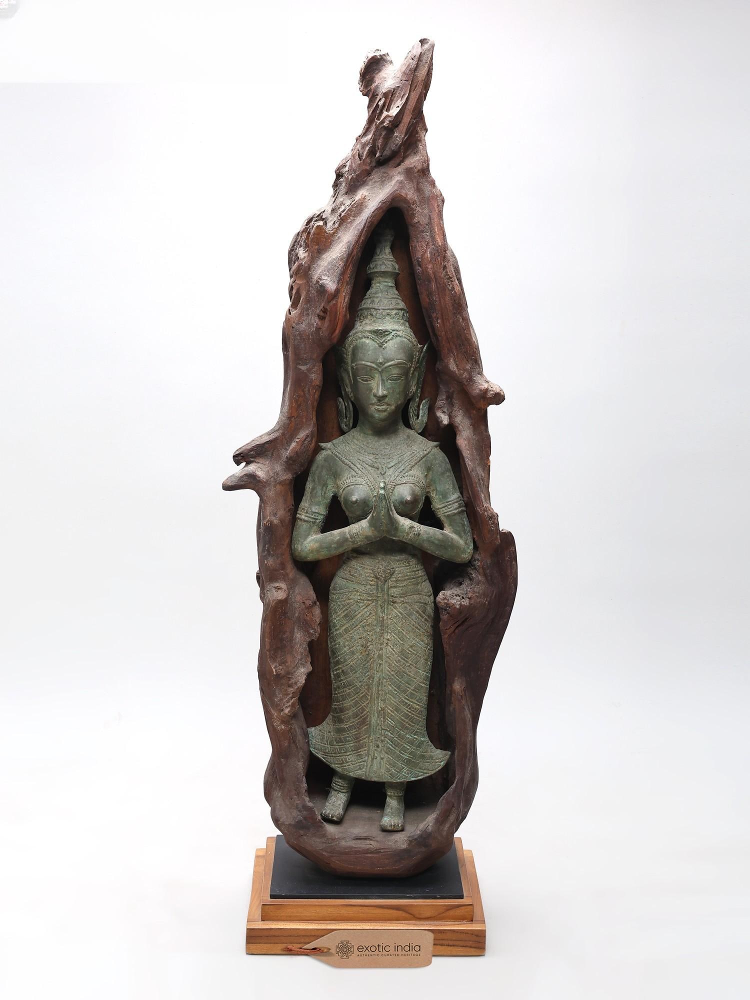39" Sacred Namaste Lady in Natural Wood Frame: A Divine Encounter in Nature's Embrace This magnificent sculpture embodies a profound spiritual serenity, presenting a gracefully poised figure in the revered Namaste pose. The traditional greeting,