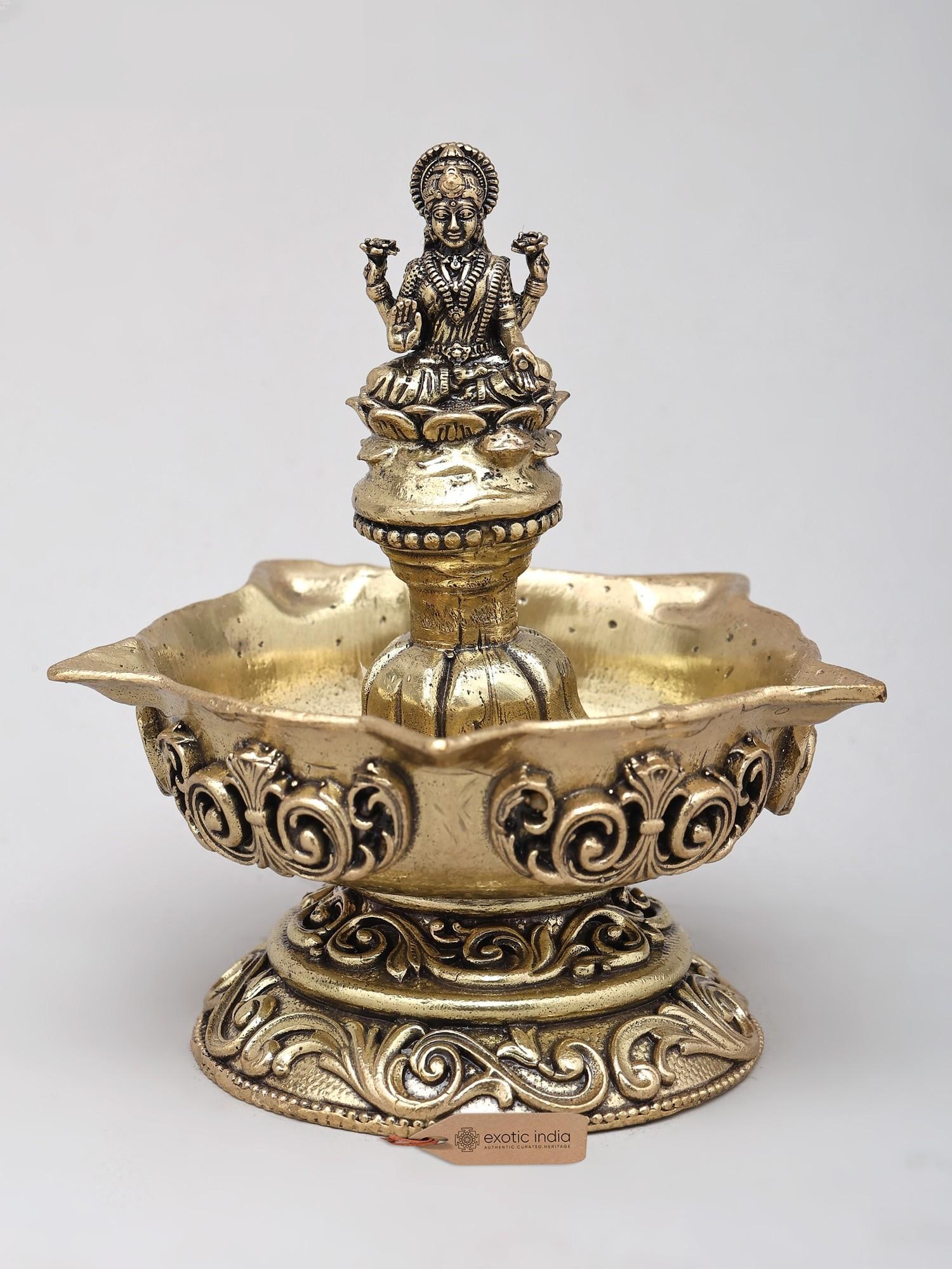 3" Small Superfine Goddess Lakshmi Lamp in Brass: A Beacon of Prosperity and Divine Grace Invoke the blessings of abundance and good fortune with this exquisite brass lamp, a divine vessel designed to illuminate your sacred space and your life. Craft