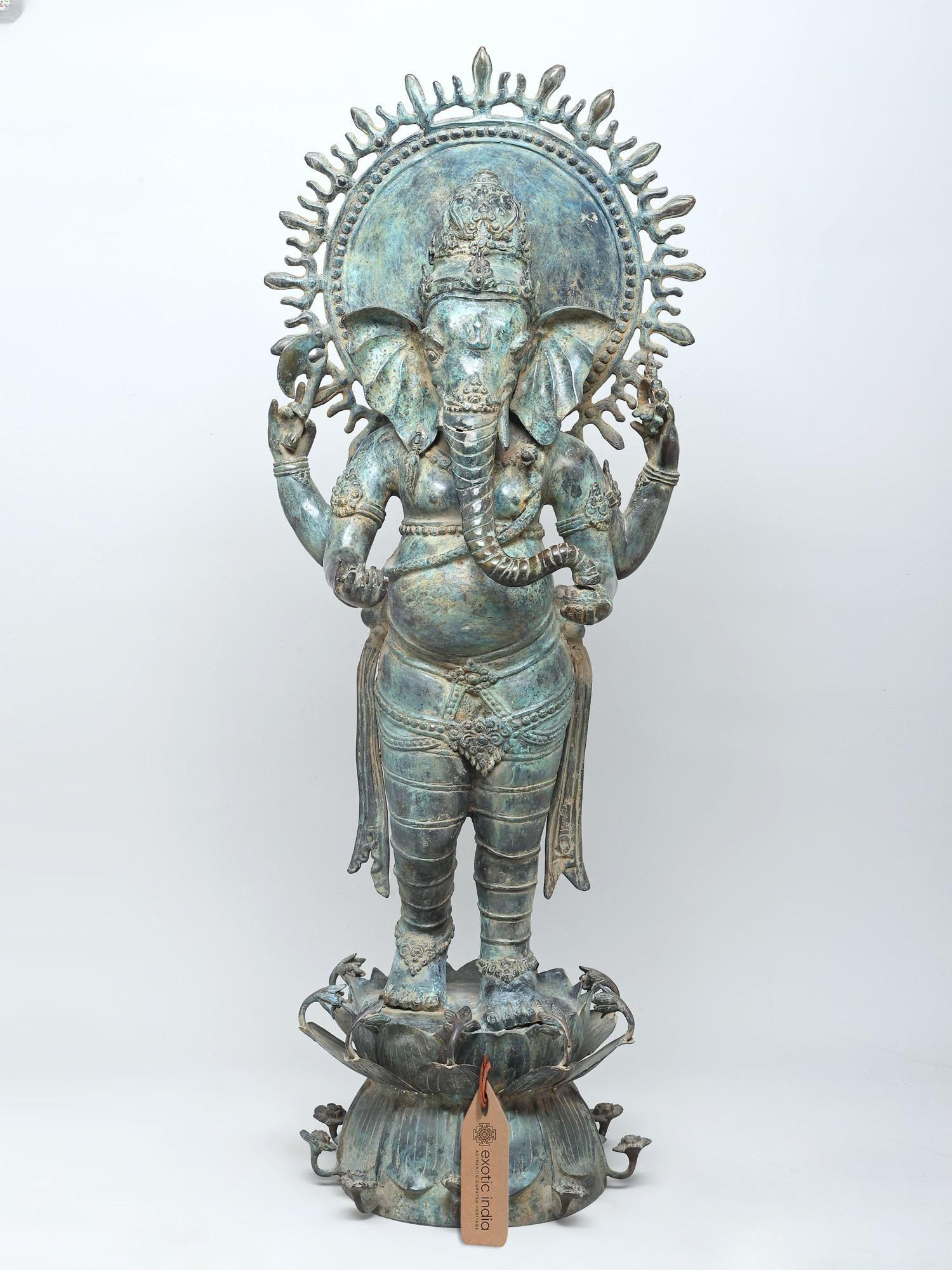 41" Large Standing Lord Ganesha on Lotus Pedestal | Brass Statue: A Majestic Presence: Lord Ganesha in Brass Behold the magnificent stature of Lord Ganesha, captured in this commanding brass representation. Standing tall and serenely on a lotus pedestal, this deity 