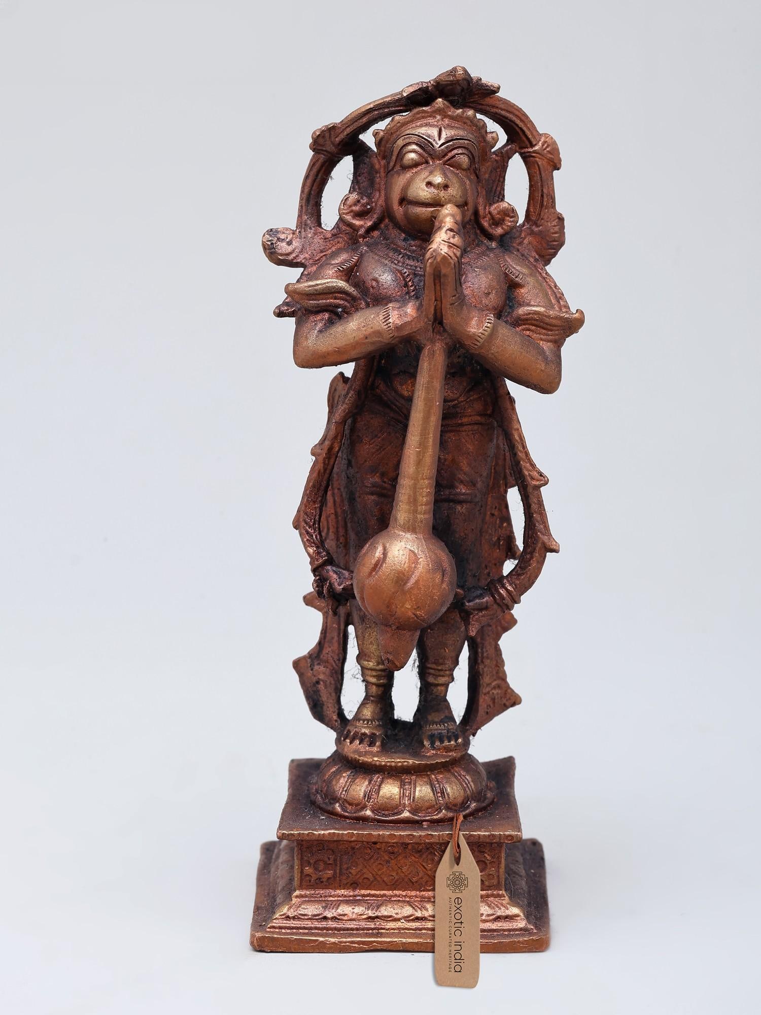 5" Small Standing Lord Hanuman | Copper Statue: The Embodiment of Devotion and Strength This exquisite copper statue captures the divine form of Lord Hanuman, the devoted warrior and loyal servant of Lord Rama. In this pose, Hanuman stands with his