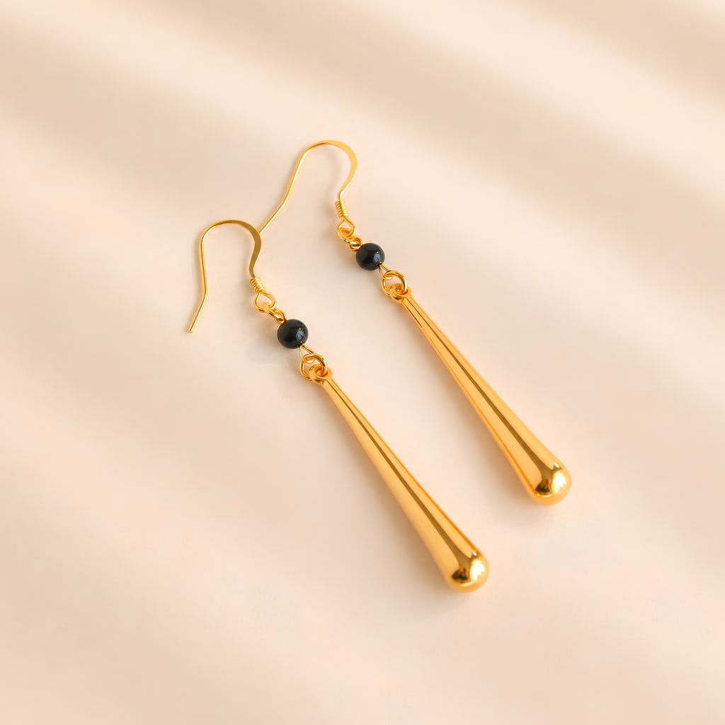 Gold Modern Earrings with Onxy Accent: Title:Gold Modern Earrings with Onxy Accent Description:These gold drop earrings feature polished elongated gold drops accented with black onyx beads. The tapered shape and smooth finish create a