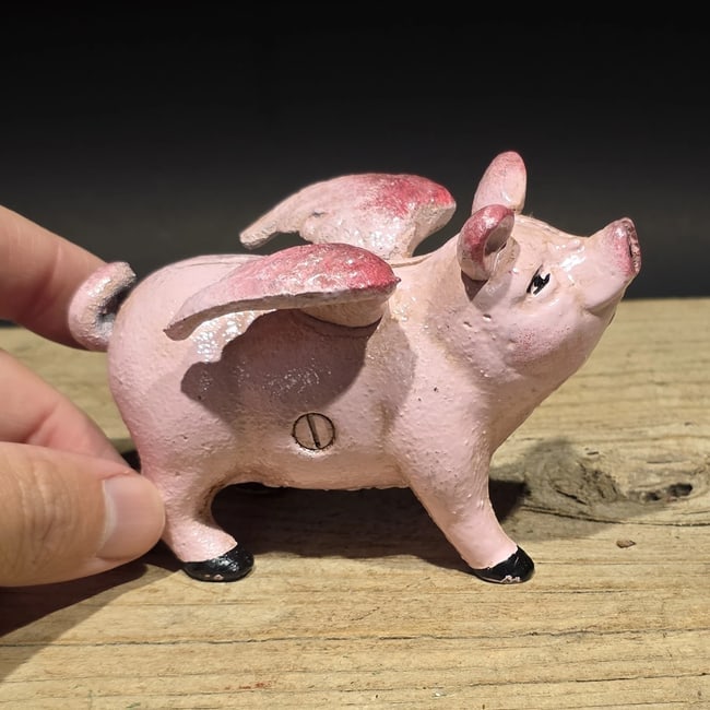 4" Cast iron Flying Pig Coin Bank: Gemini saidReproduction Cast iron coin bank in the form of a winged flying pig, a whimsical novelty design inspired by early figural banks and folk art humor. Animal-form banks became especially popul