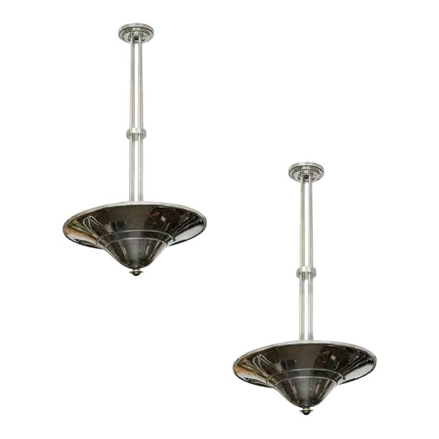 Streamline Art Deco Chrom Steel Saturn Saucer Ceiling Pendant Lamp, Pair: Title: Streamline Art Deco Chrom Steel Saturn Saucer Ceiling Pendant Lamp, Pair Description: Streamline Art Deco era chrome "Saturn" saucer ceiling lamp pair featuring a bronze end cap and polished al