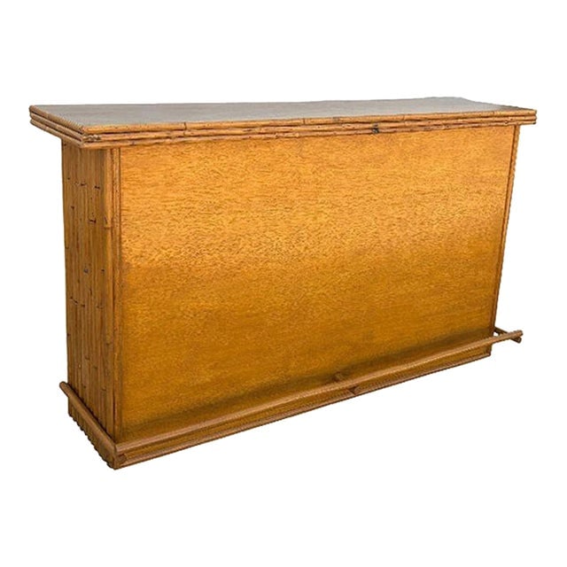 Restored Mid-Century Rattan & Mahogany Bar W/ Foot Rest: Title: Restored Mid-Century Rattan & Mahogany Bar W/ Foot Rest Description: Large 42" wide Mahogany wood dry bar with vertically stacked rattan sides and a Mahogany top. The bar has two shelves along