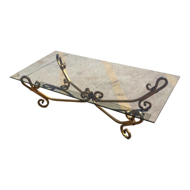 Gold-Tone Gilded Wrought Iron Hollywood Regency Cocktail Table W/ Glass Top: Title: Gold-Tone Gilded Wrought Iron Hollywood Regency Cocktail Table W/ Glass Top Description: Mid-century era Hollywood Regency Gilded gold-tone Wrought Iron Cocktail Table with a glass top. The wro
