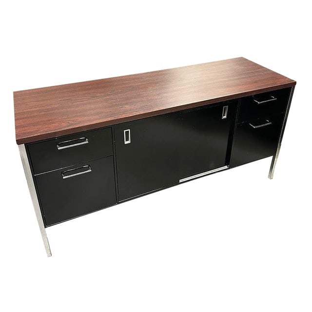 1970s Modern Black & Chrome Metal Tanker Credenza by Steelcase: Title: 1970s Modern Black & Chrome Metal Tanker Credenza by Steelcase Description: Vintage Modern black enameled steel tanker Credenza with chromed legs and Walnut Laminate Top. This credenza was made