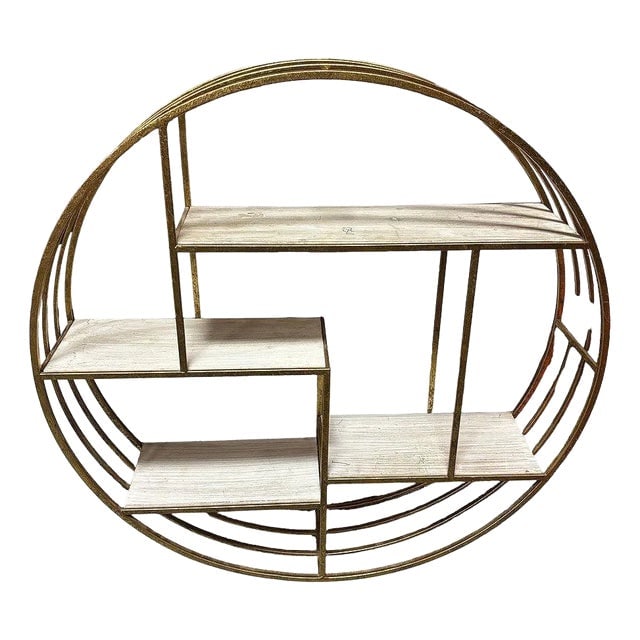1990s Mid-Century Style 4-Tier Round Brass Colored Wall Hanging Shelf: Title: 1990s Mid-Century Style 4-Tier Round Brass Colored Wall Hanging Shelf Description: 4-tier Mid-century wall-hanging shelves feature a striking round brass-colored metal frame. The shelves are