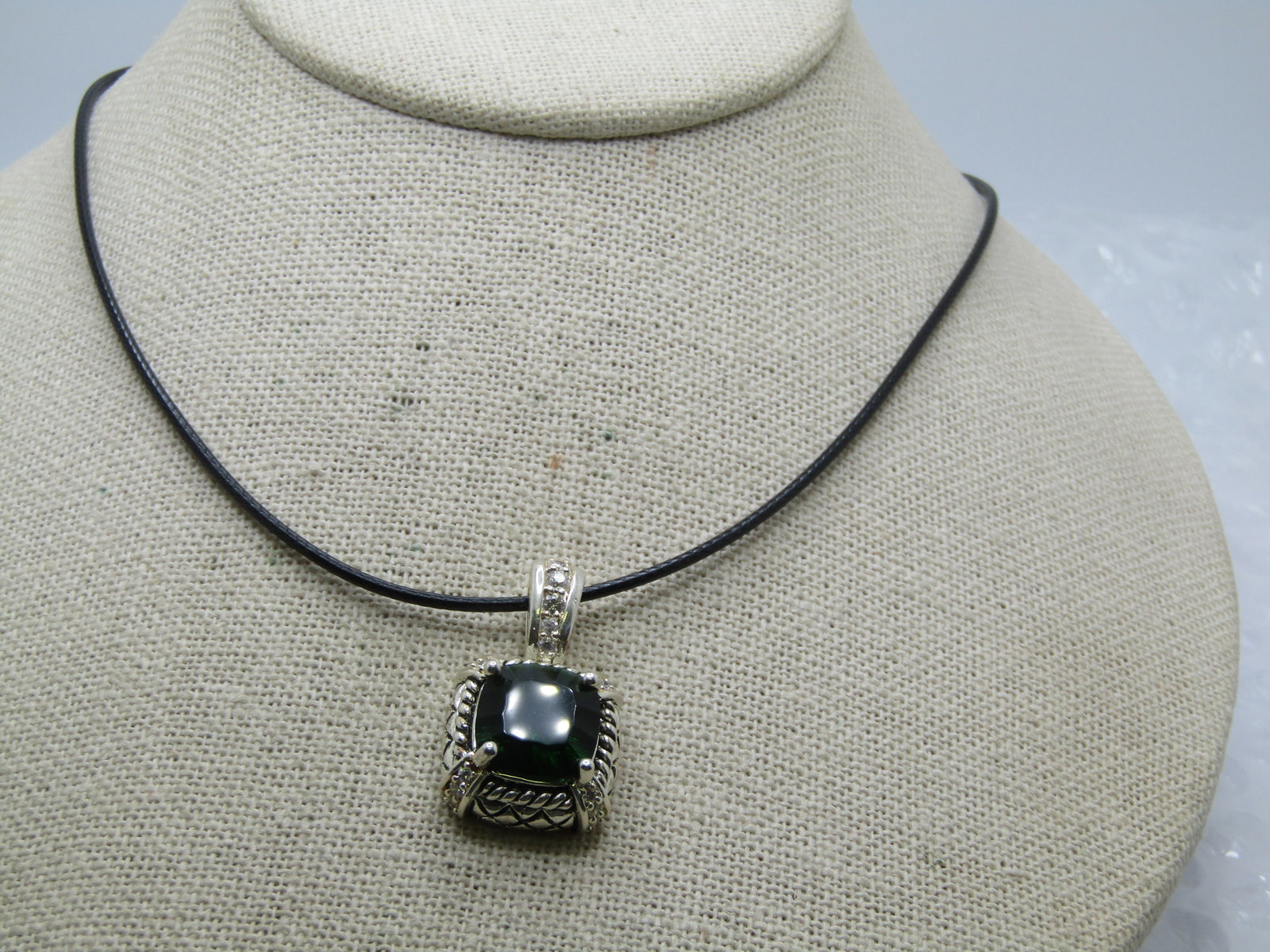 Silver Plated Green & Clear Rhinestone Necklace, 20" Black Cord: Title: Silver Plated Green & Clear Rhinestone Necklace, 20" Black Cord Description: Silver Plated Green & Clear Rhinestone Necklace, 20" Black Cord. This has a Silver plated pendant with a large green