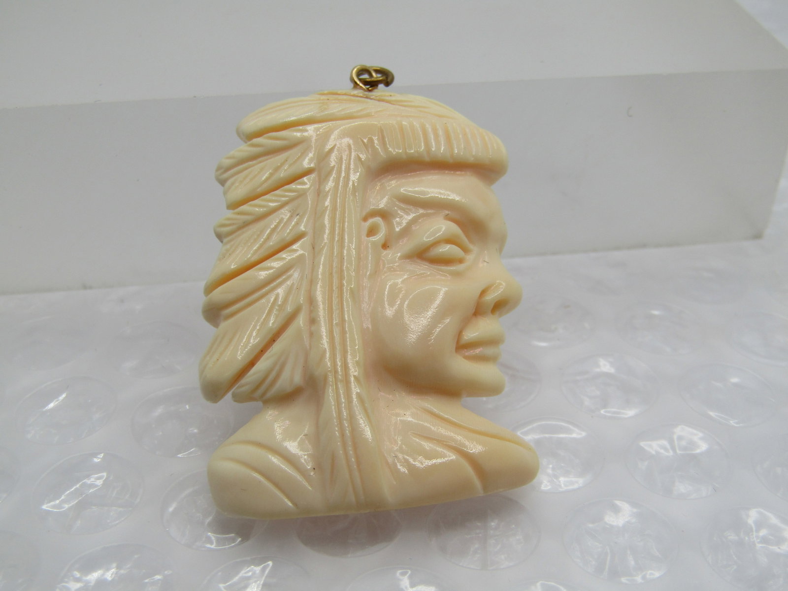 Vintage Glass Native American Chief Pendant, 1.75": Title: Vintage Glass Native American Chief Pendant, 1.75" Description: Vintage Glass Native American Chief Pendant, 1.75" tall and 1.25" wide. Nice detail. It is not marked or signed. Age is estimated