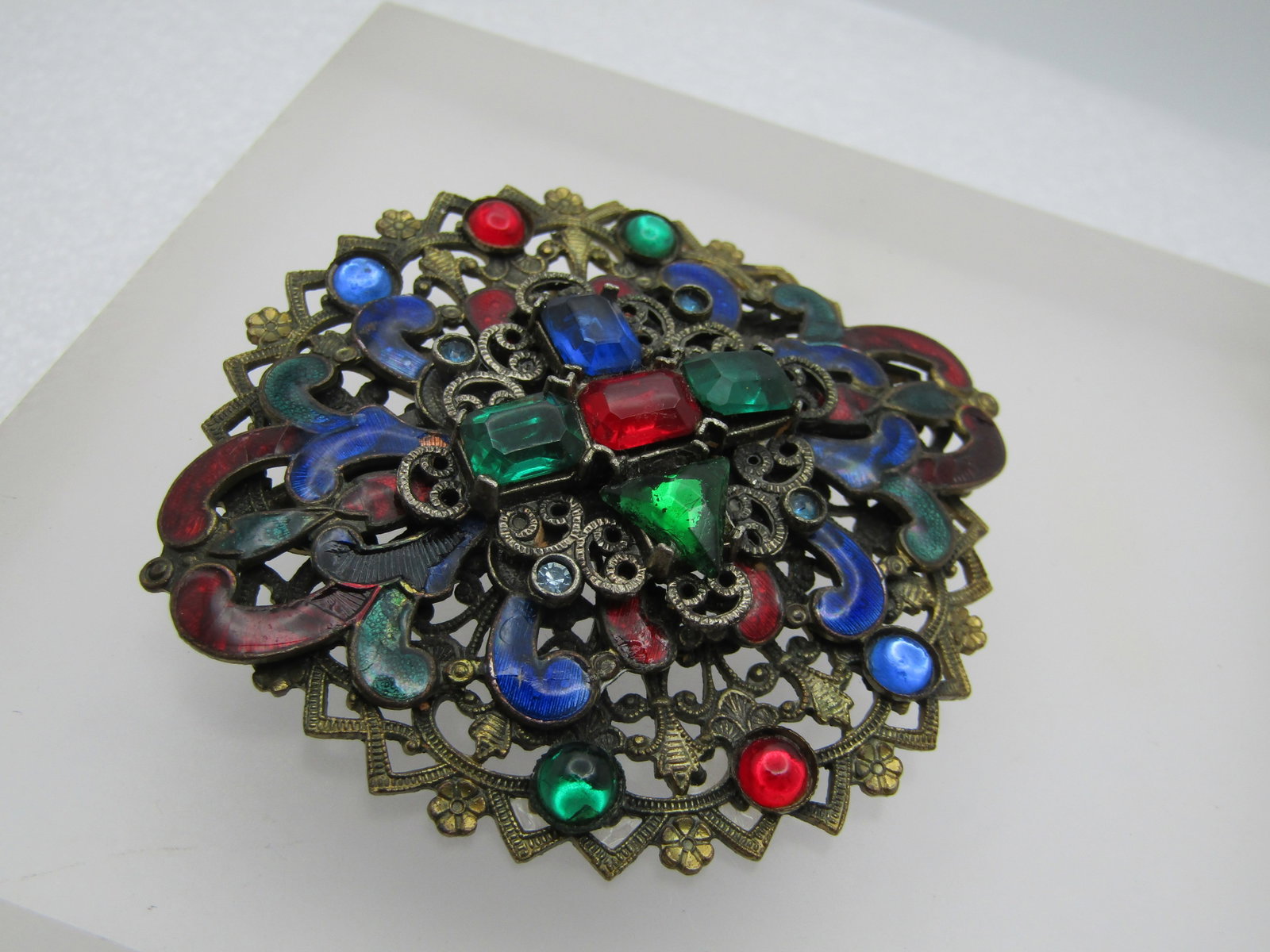 Vintage Enameled & Rhinestone Brooch, 1920's-1930's: Title: Vintage Enameled & Rhinestone Brooch, 1920's-1930's Description: Vintage Enameled & Rhinestone Brooch, 1920's-1930's. Filigree brassy gold tone tiered setting with enameled scrolls in red, gree