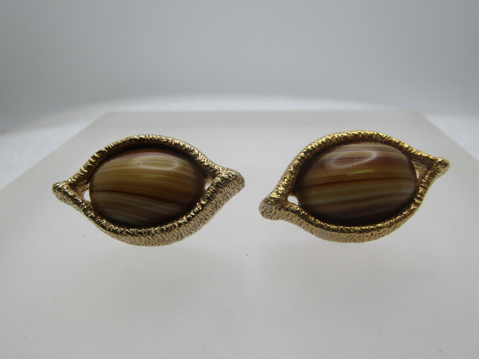 Vintage Cateye Cufflinks, Brown Glass, 1950's-1970's: Title: Vintage Cateye Cufflinks, Brown Glass, 1950's-1970's Description: Vintage Cateye Cufflinks, Brown Glass, 1950's-1970's. Gold tone textured setting in the shape of an eye with a center oval shad