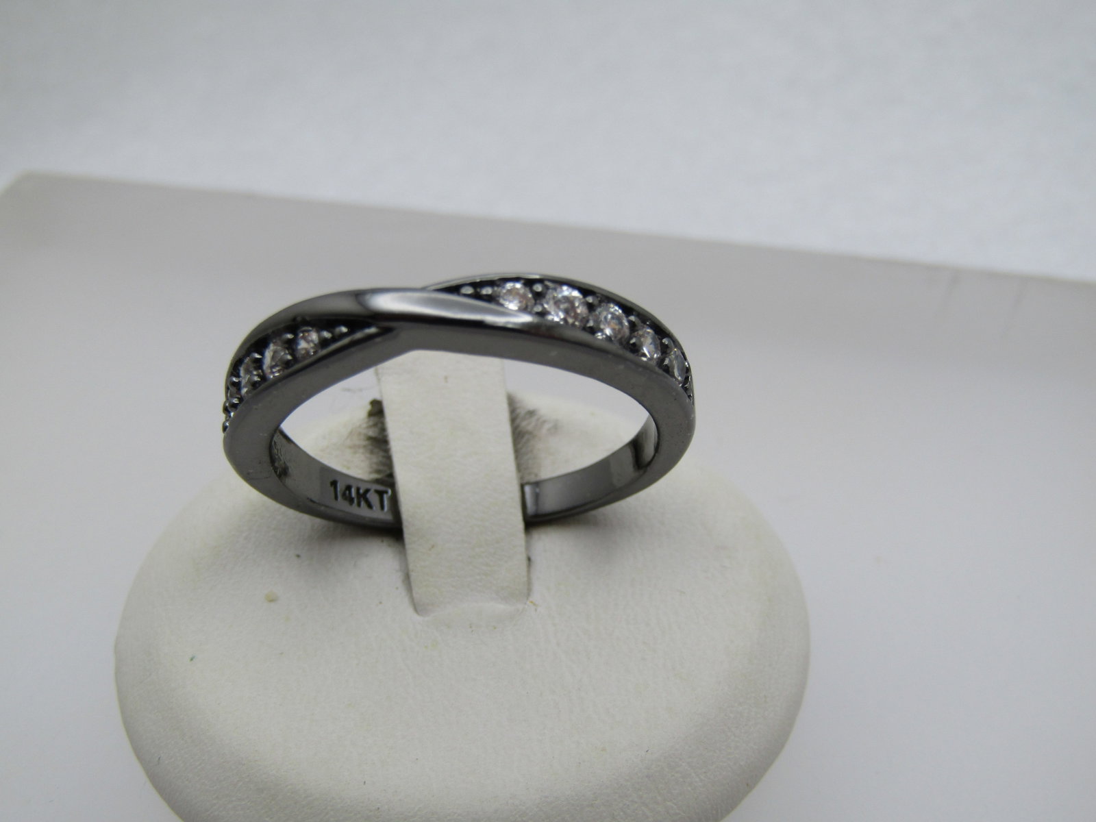 Titanium Tone Rhinestone Band Ring, Sz. 11.25. 2000's: Title: Titanium Tone Rhinestone Band Ring, Sz. 11.25. 2000's Description: Crossover style band that is appx. 4mm wide with five mixed size clear rhinestones. It is marked 14kt - which this is not 14kt