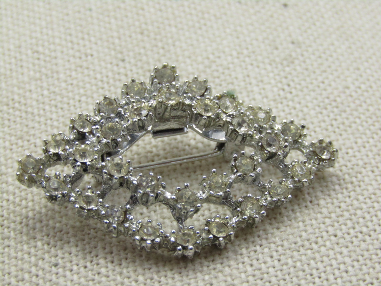 Vintage Tiered Rhinestone Brooch, Diamond Shaped, 1950's-1960's: Title: Vintage Tiered Rhinestone Brooch, Diamond Shaped, 1950's-1960's Description: Vintage Tiered Rhinestone Brooch, Diamond Shaped, 1950's-1960's. 1.75" by 1.25" . Clear 2mm round rhinestones set in