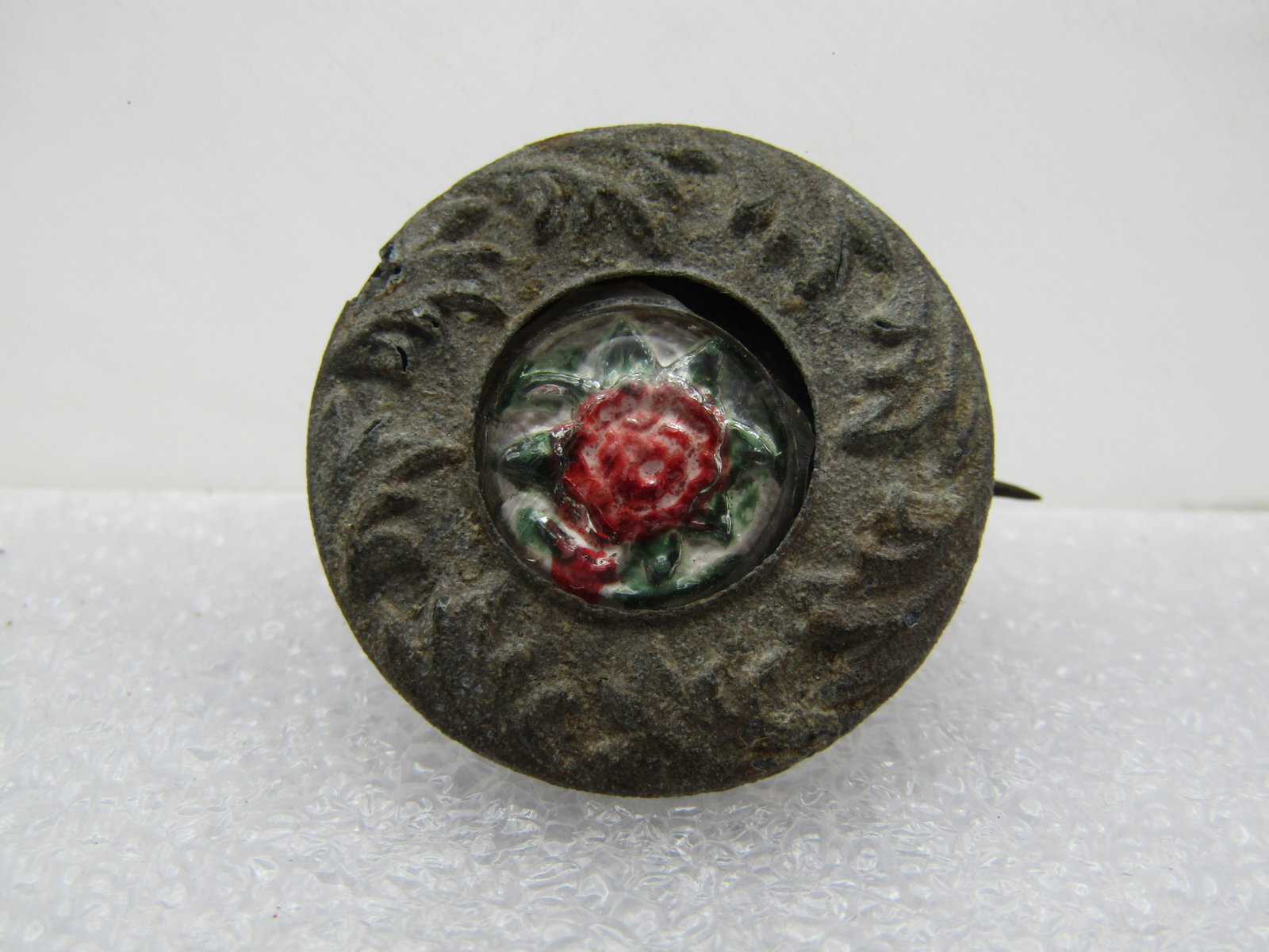 Antique Floral Glass Pressed Metal Brooch, C-Clasp, 1800's. Pressed silver tone metal with a: Title: Antique Floral Glass Pressed Metal Brooch, C-Clasp, 1800's. Pressed silver tone metal with a center of a domed pink glass flower with green leaves that peaks out of the center. This has finish 