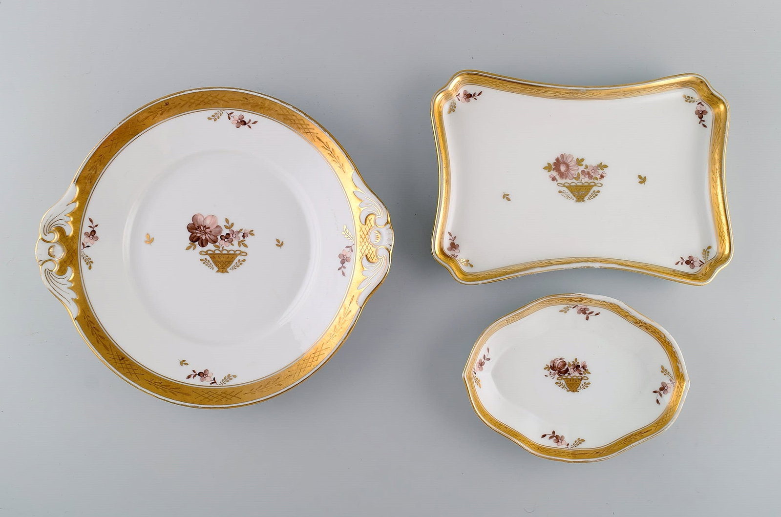 Three Royal Copenhagen Golden Basket dishes in porcelain with flowers and gold decoration. Early - 2