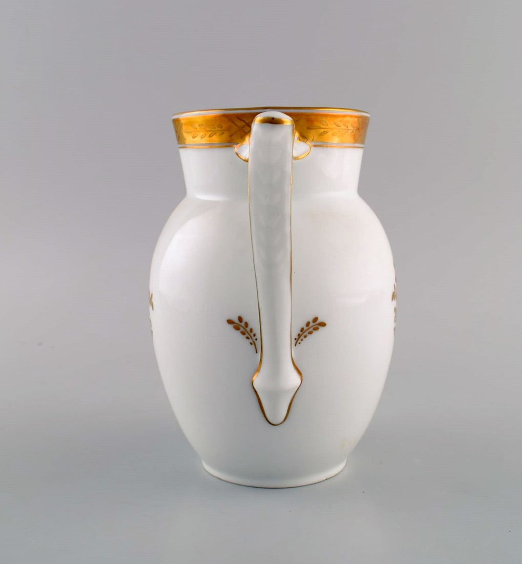 Royal Copenhagen Golden basket jug in porcelain with flowers and gold decoration. Model number - 6