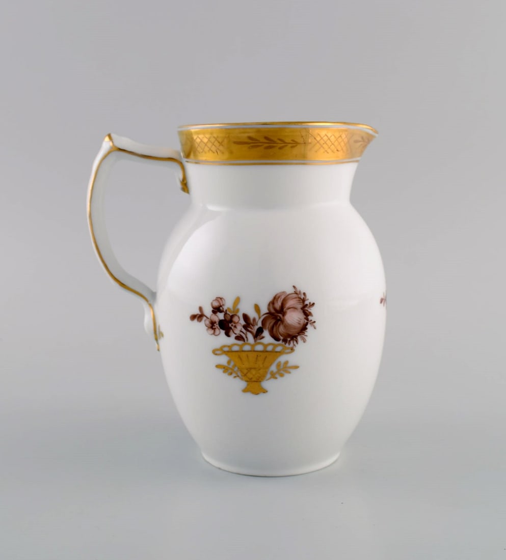 Royal Copenhagen Golden basket jug in porcelain with flowers and gold decoration. Model number - 3