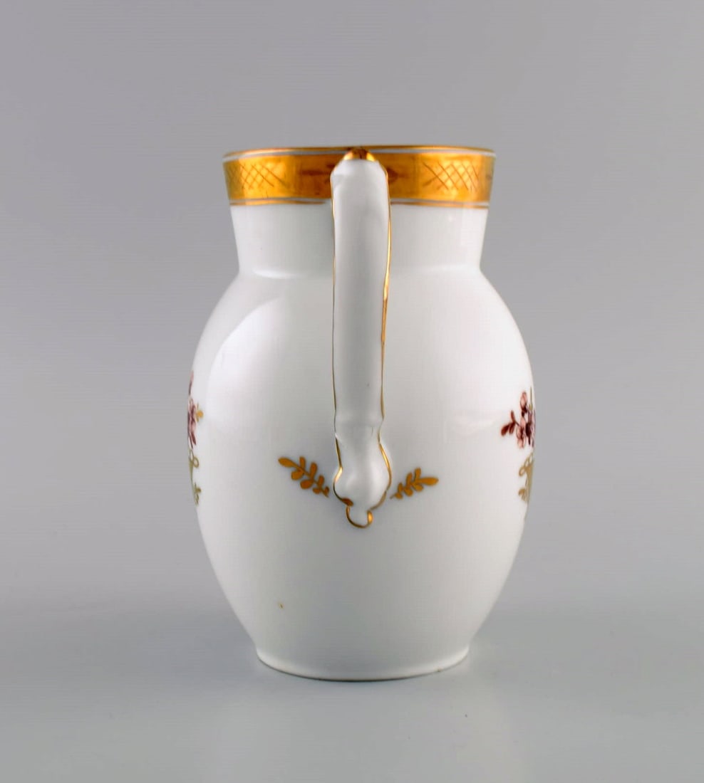 Royal Copenhagen Golden basket jug in porcelain with flowers and gold decoration. Model number - 5