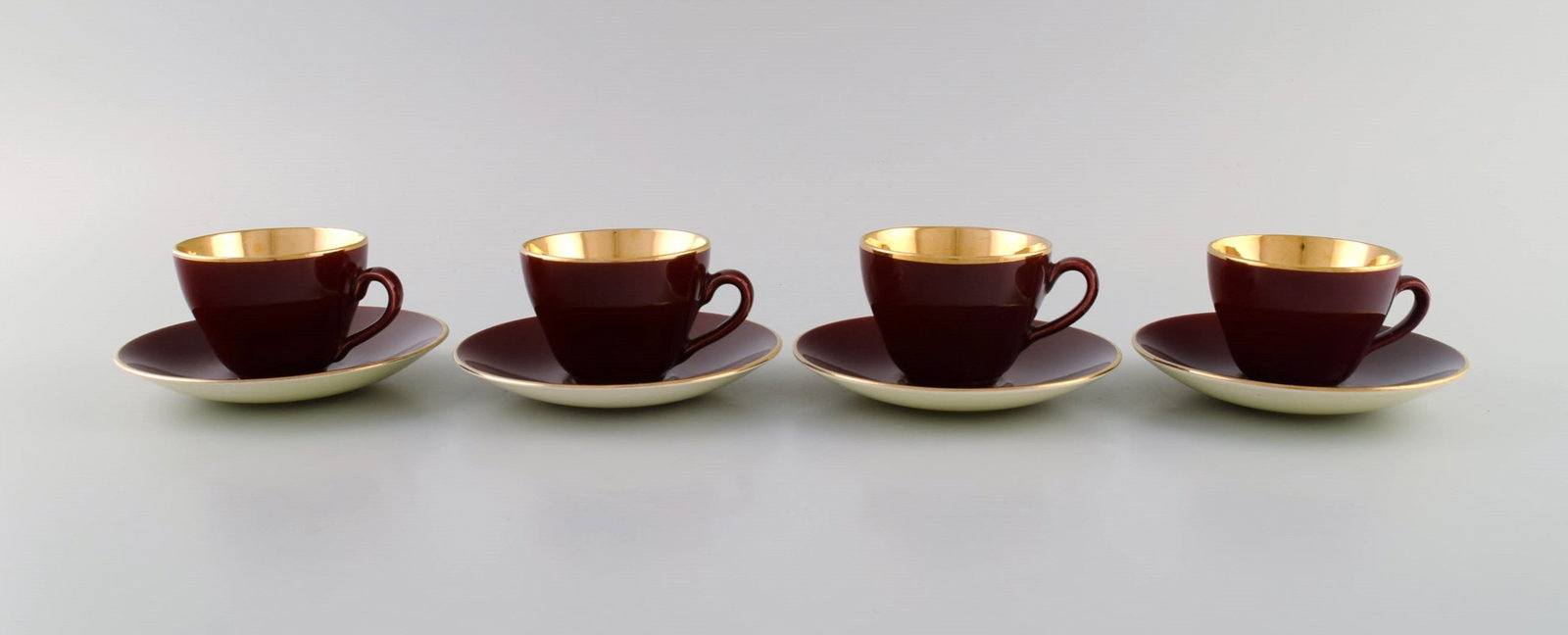Four Royal Copenhagen / Aluminia Confetti mocha cups with saucers in glazed faience with interior: Title: Four Royal Copenhagen / Aluminia Confetti mocha cups with saucers in glazed faience with interior gold. Mid-20th century. Description: Four Royal Copenhagen / Aluminia Confetti mocha cups with 