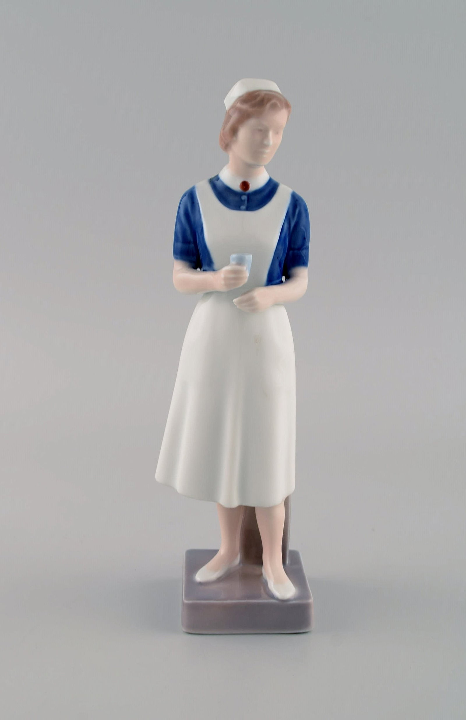 Royal Copenhagen porcelain figurine. Nurse. Model 4507. Dated 1969-1974.: Title: Royal Copenhagen porcelain figurine. Nurse. Model 4507. Dated 1969-1974. Description: Royal Copenhagen porcelain figurine. Nurse. Model 4507. Dated 1969-1974. Measures: 21.5 x 6.5 cm. In excell
