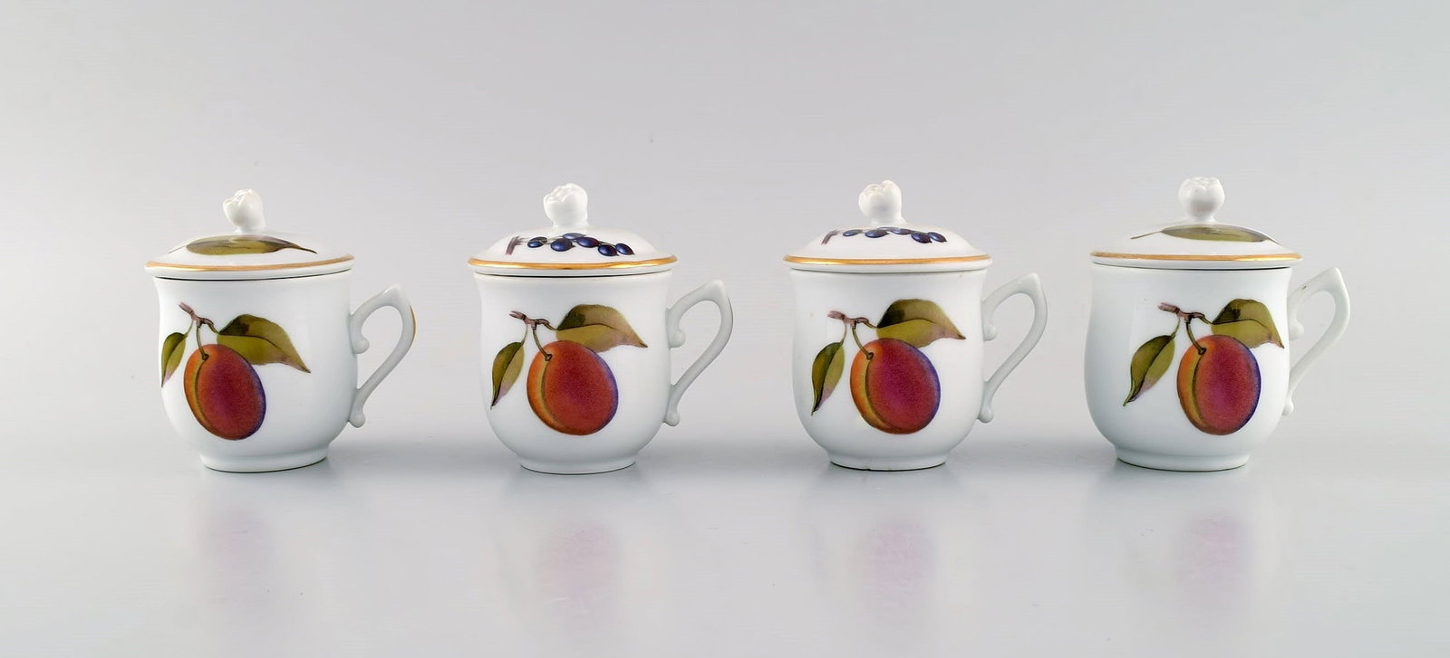 Royal Worcester, England. Four Evesham porcelain cream cups decorated with fruits and gold edge. (1 of 6)