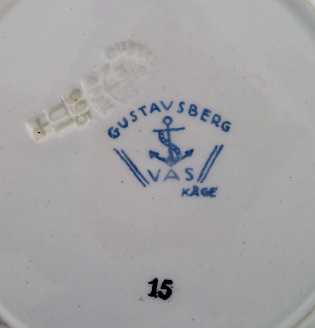 Wilhelm Kage for Gustavsberg. Vas serving dish and fifteen plates in hand-painted faience. 1920s / - 8