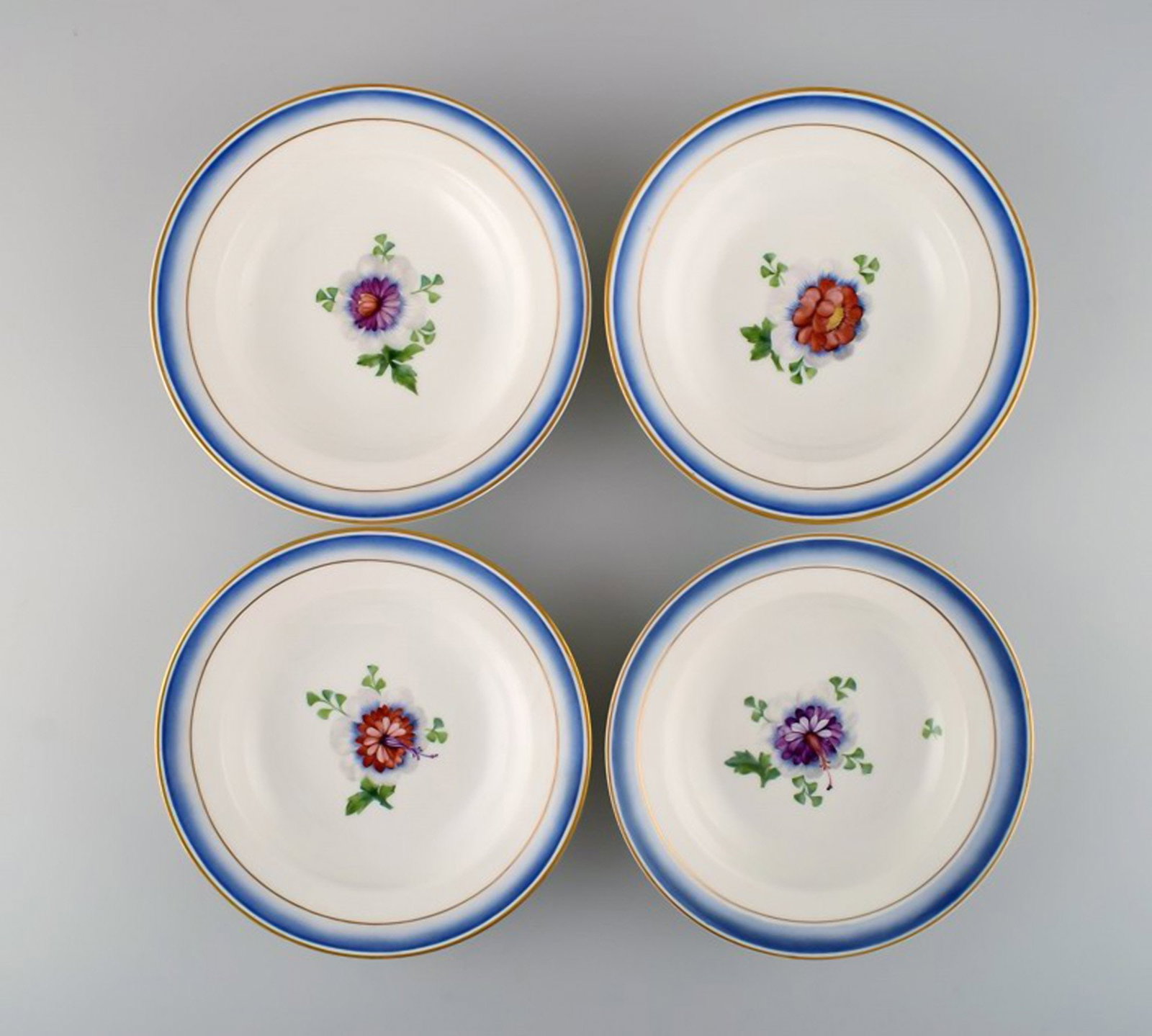 Four antique Royal Copenhagen deep plates in hand-painted porcelain with flowers and blue edge with - 2