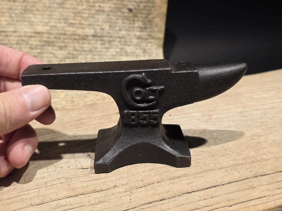 Colt 1855 Miniature Anvil Cast Iron Gunsmith Paperweight: 6" Heavy, cast iron miniature anvil featuring the iconic Colt logo and the historical date 1855 the year the Colt Patent Firearms Manufacturing Company was formally incorporated. This piece serves as 