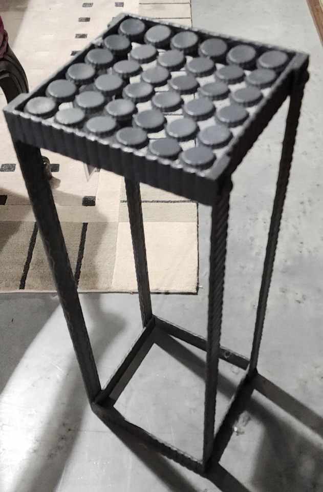 Modern folk art brutalist pedestal made from rebar and bottle caps: Modern folk art brutalist pedestal made from rebar and bottle caps Reserve: $80.00 Shipping: Domestic: Shipping rates are determined by destination International: Foreign shipping rates are