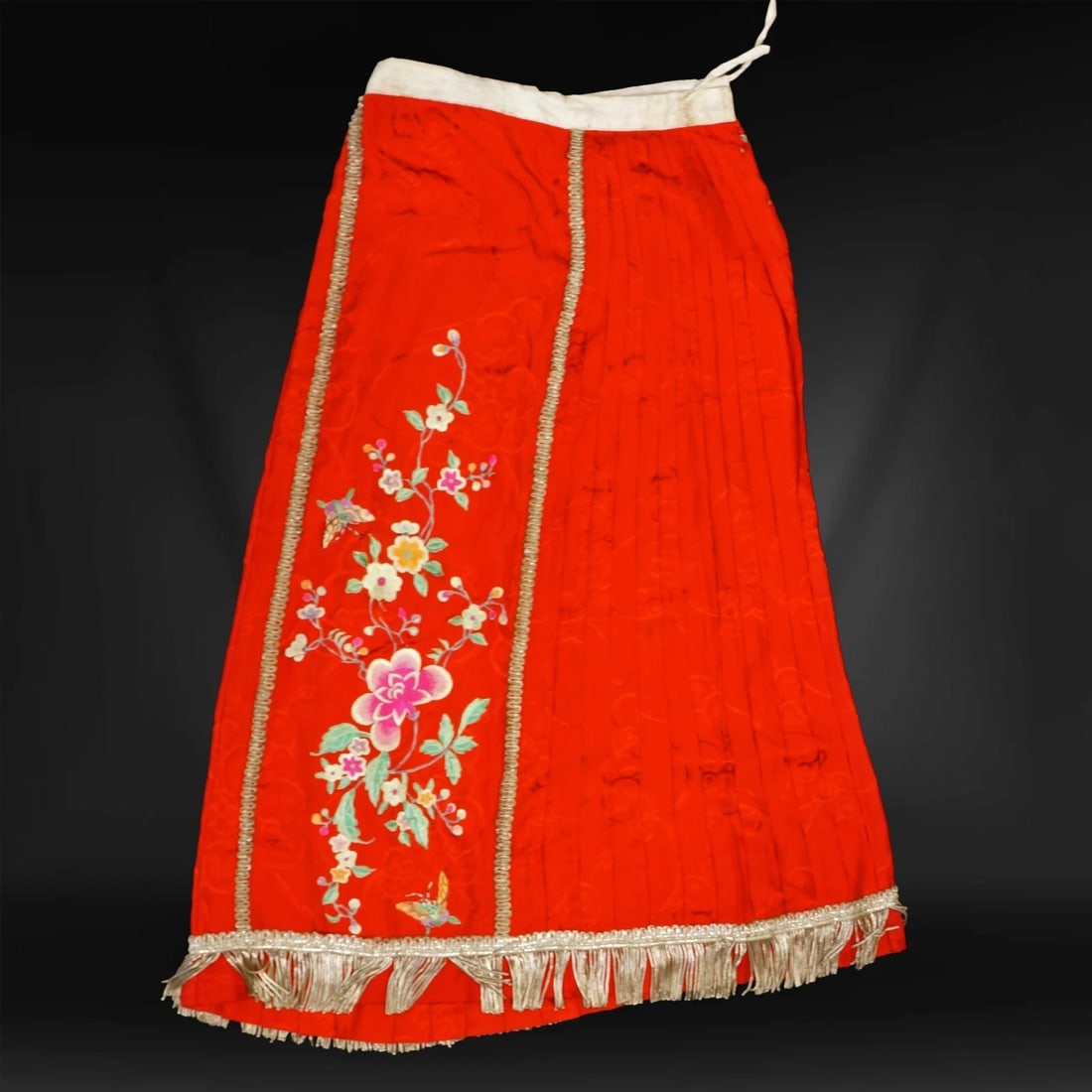 1920s Chinese Red Silk Skirt w/ Metal Fringe: Title:1920s Chinese Red Silk Skirt w/ Metal Fringe Size:28 in (71.1 cm) waist x 33 in (83.8 cm) long. Description:A happy red women’s skirt with silk appliques that is weighted on the bottom with