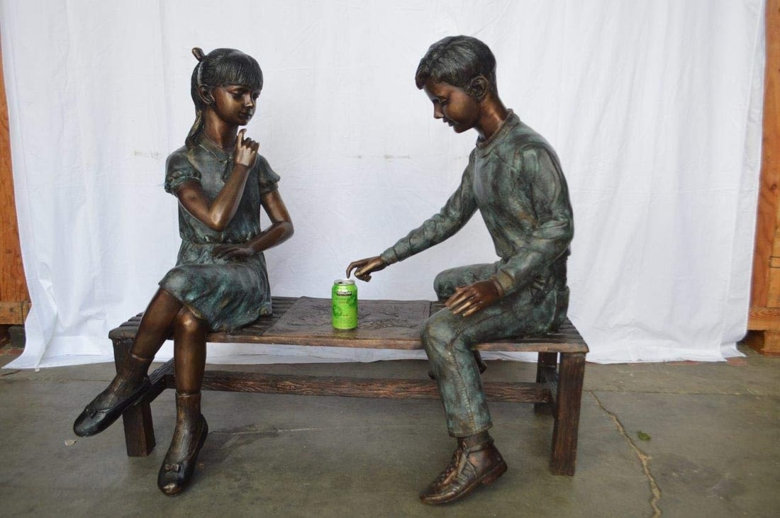 Young Couple Reviewing a World Map Bronze Statue - Size: 32"L x 47"W x 42"H. - 3